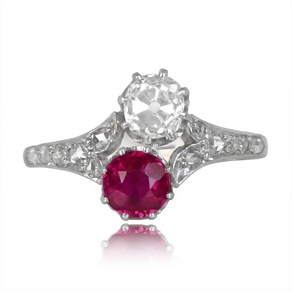 An antique Edwardian-era ring showcasing two stunning gemstones: an antique cushion cut diamond weighing around 0.50 carats (H color, SI2 clarity) and a round natural ruby weighing 0.60 carats. Both gems are prong-set, accompanied by a leaf motif of