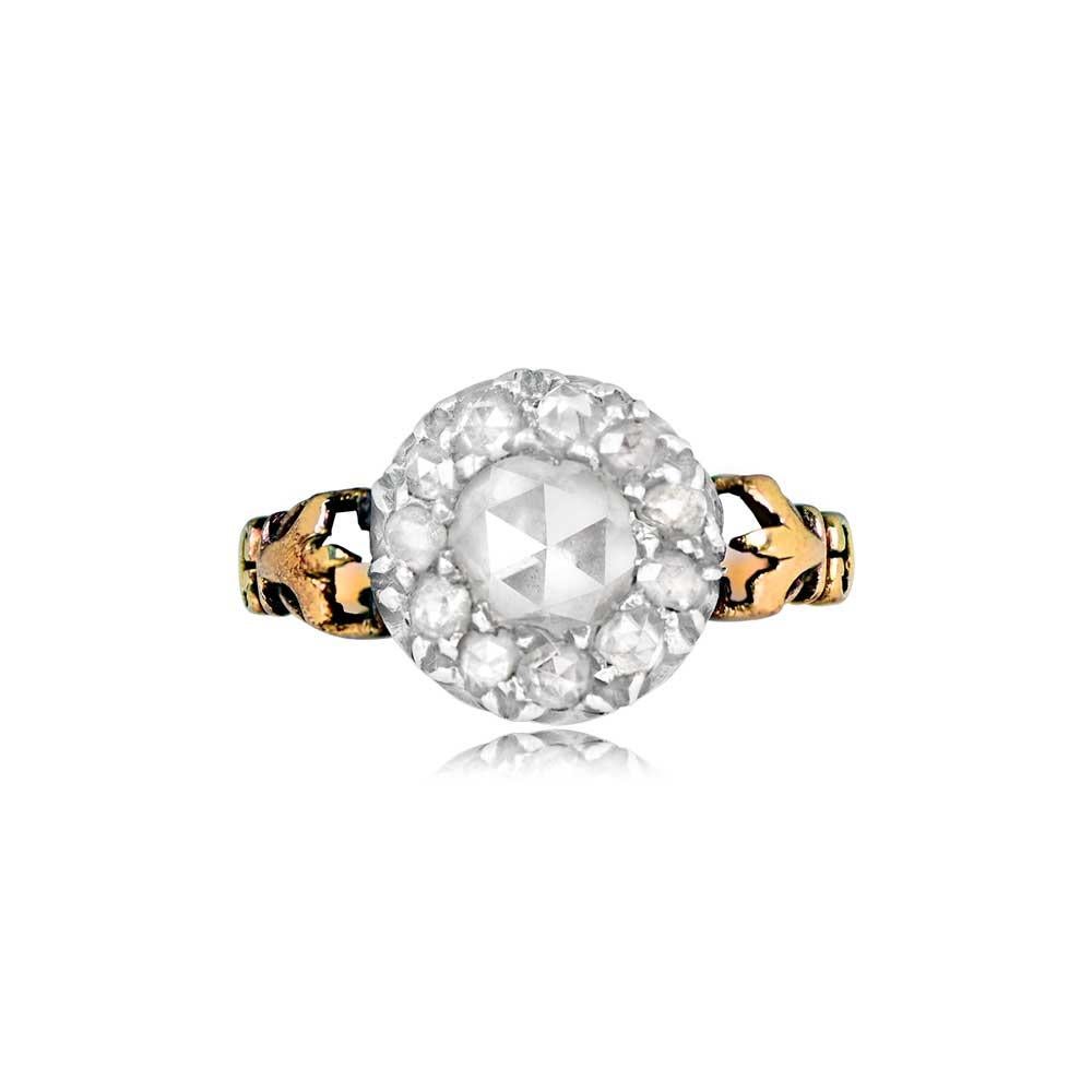 This exquisite antique engagement ring hails from the Georgian era, circa 1810. It showcases a central round rose-cut diamond, weighing around 0.50 carats, with a charming J color and remarkable VS2 clarity. Surrounding the center stone is a