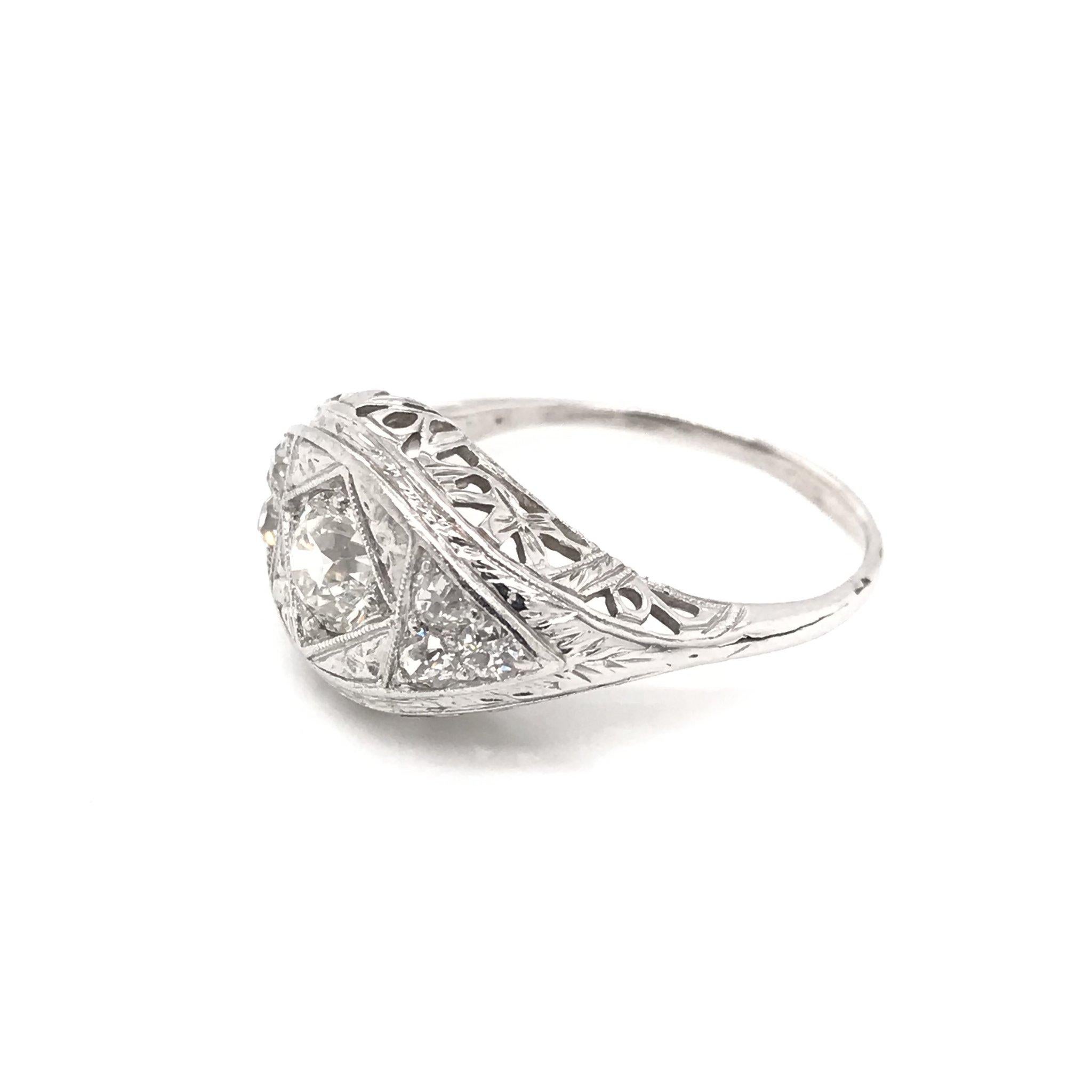 This beautiful antique piece was handcrafted sometime during the Art Deco design period ( 1920-1940 ). The exquisite 14k white gold filigree setting features a sparkling center diamond measuring approximately 0.55 carats. The center diamond grades