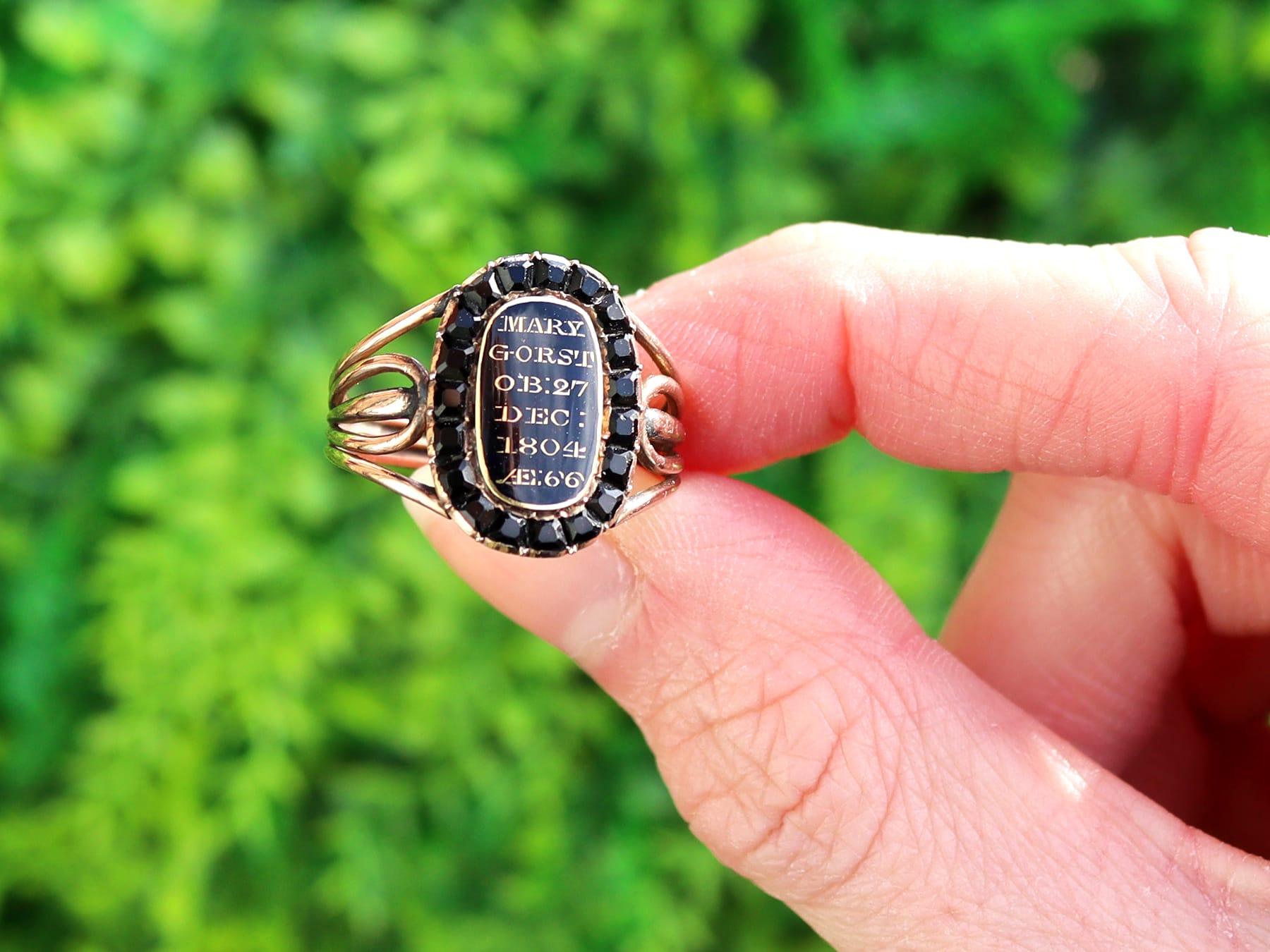 A fine and impressive antique Georgian 0.57 carat jet, black enamel and 9 karat yellow gold mourning ring; part of our diverse antique mourning jewellery collections.

This fine and impressive antique Georgian mourning ring has been crafted in 9k