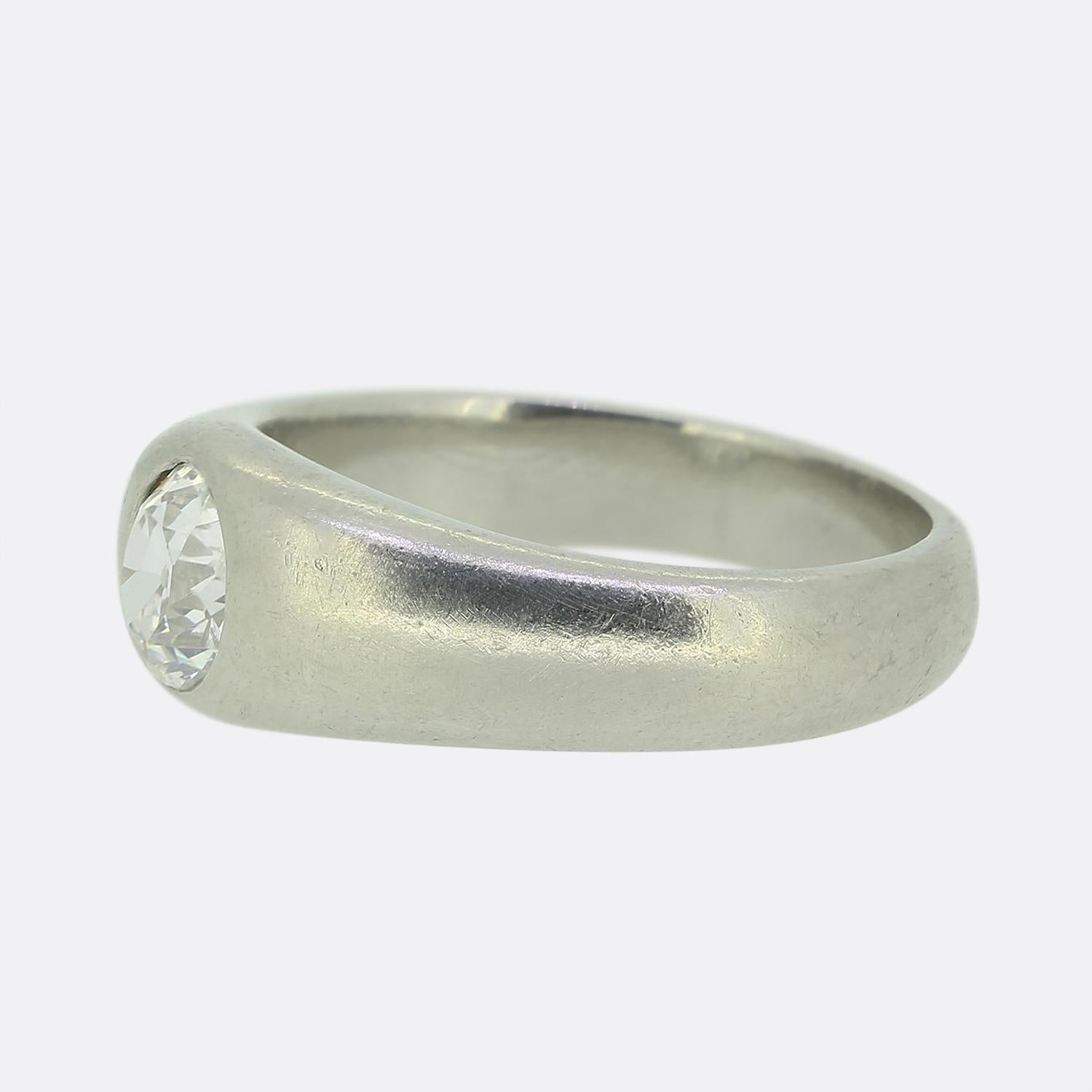Here we have refined single stone ring showcasing a captivating old mine-cut diamond as its focal point. This exquisite white diamond is elegantly bezel set at the centre of the face within a smooth platinum band, exuding timeless charm.

Condition: