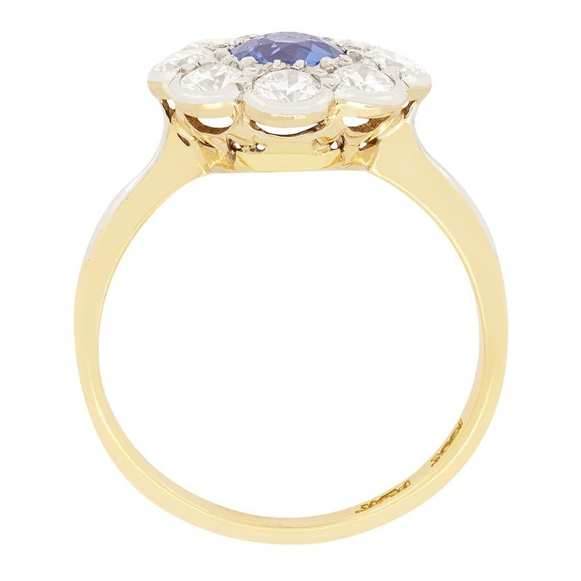 This exquisite Antique cluster ring dates back to the 1920s. At it’s centre, a captivating old cut sapphire sits, weighing 0.65 carat. Surrounding the sapphire are eight sparkling old cut diamonds, with a combined weight of 1.20 carat. Each of the