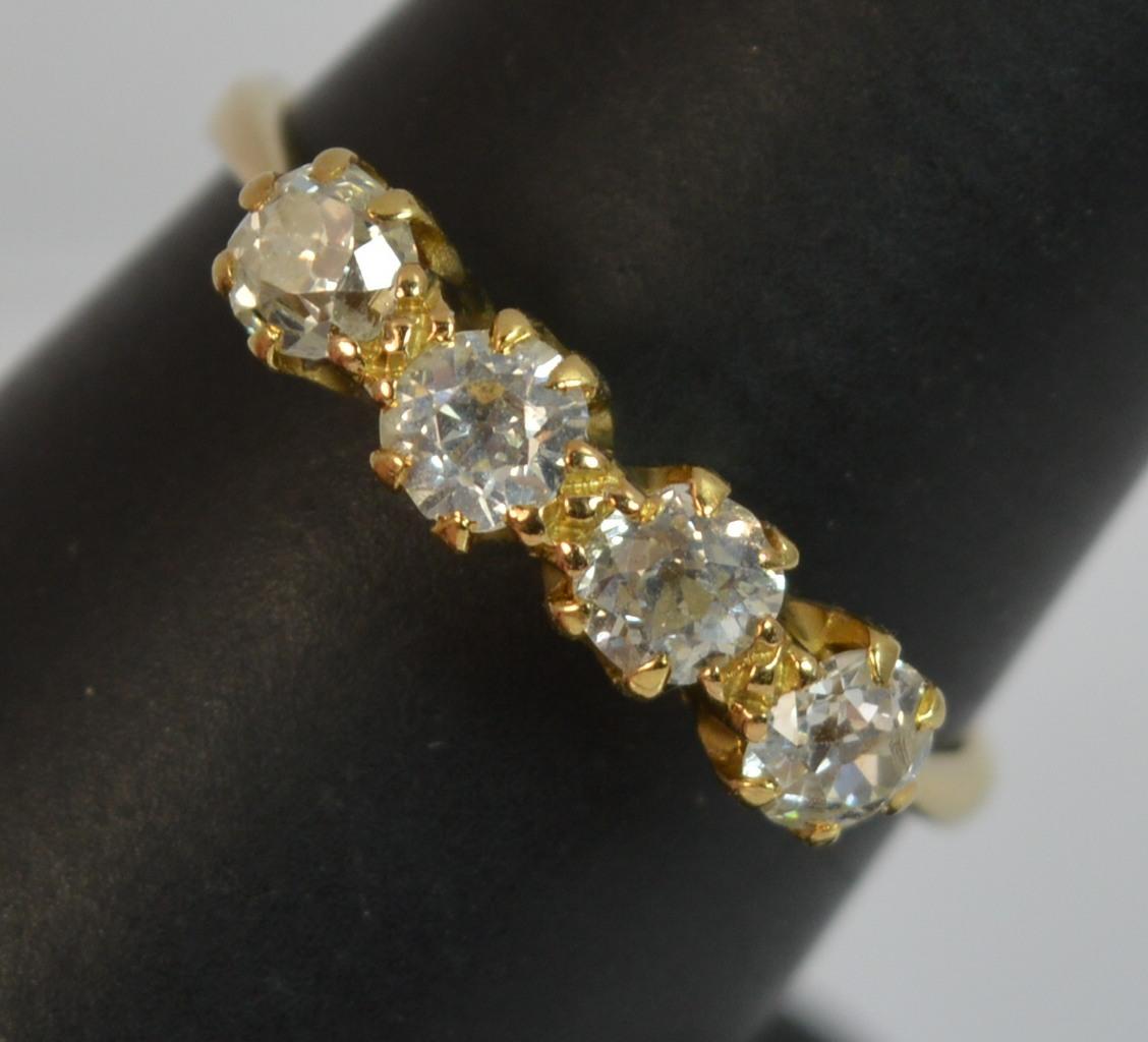 
A superb natural Diamond and 18ct Gold ring.

Set with four natural old cut diamonds in claw settings. Si clarity. 0.80 carats in total.

16mm spread of stones. 5mm off the finger.


CONDITION ; Excellent. Well set diamonds. Solid shank, light