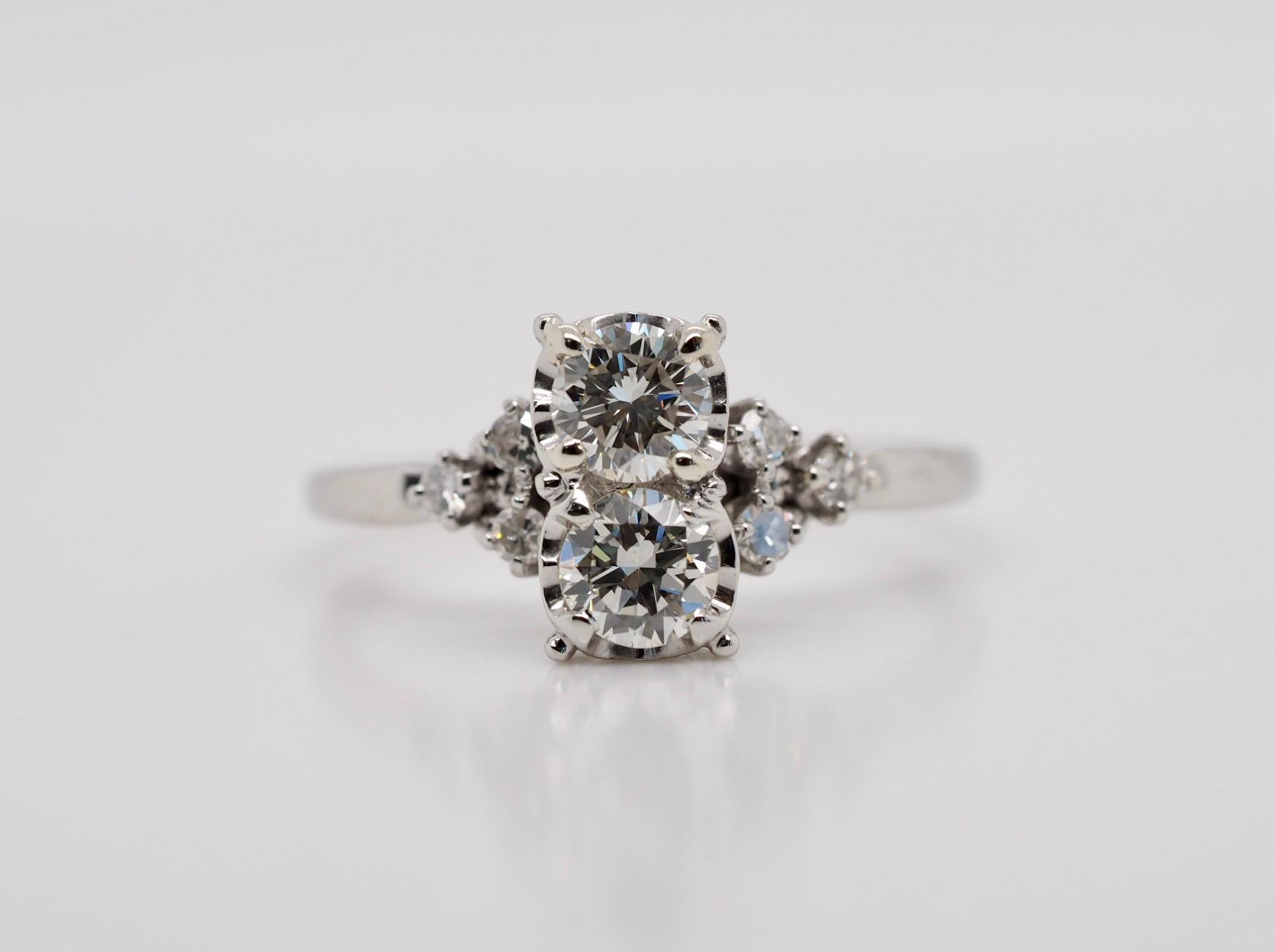 This platinum antique ring dates almost one hundred years old and is in excellent condition. The ring includes two round transitional cut diamond centers 0.80 carat total weight measuring 4.7mm each. Color H, clarity VS. There are three round