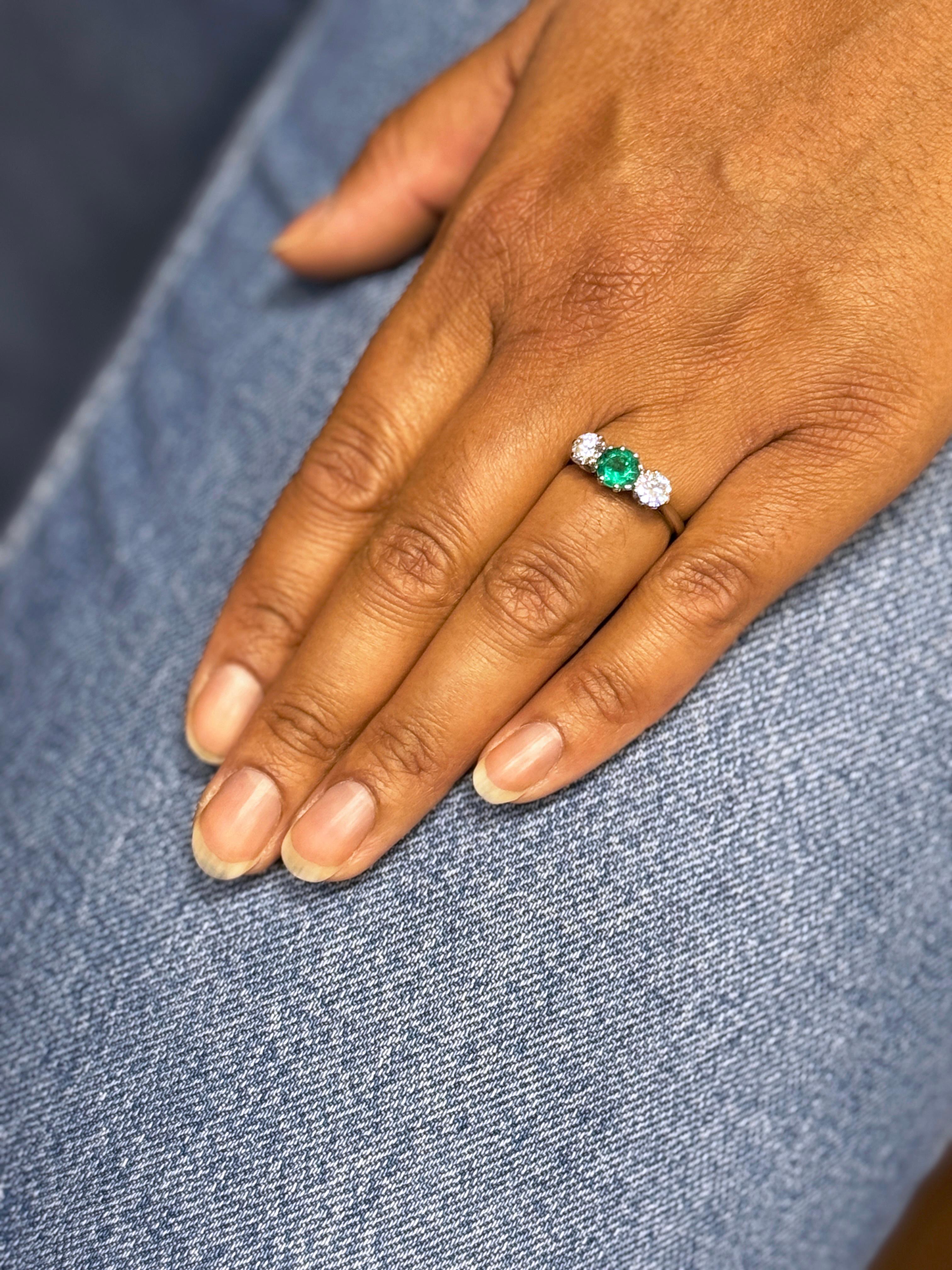Women's Antique 0.95 Carat Emerald and Diamond Three Stone Platinum Ring For Sale