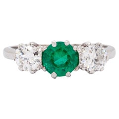Antique 0.95 Carat Emerald and Diamond Three Stone Platinum Ring