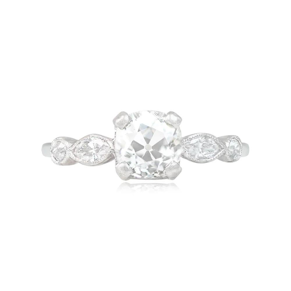 An antique engagement ring features a prong-set old European cut diamond weighing around 0.95 carats (I color, SI1 clarity). Marquise-cut and single-cut diamonds in bezel settings adorn the shoulders, with a total additional diamond weight of