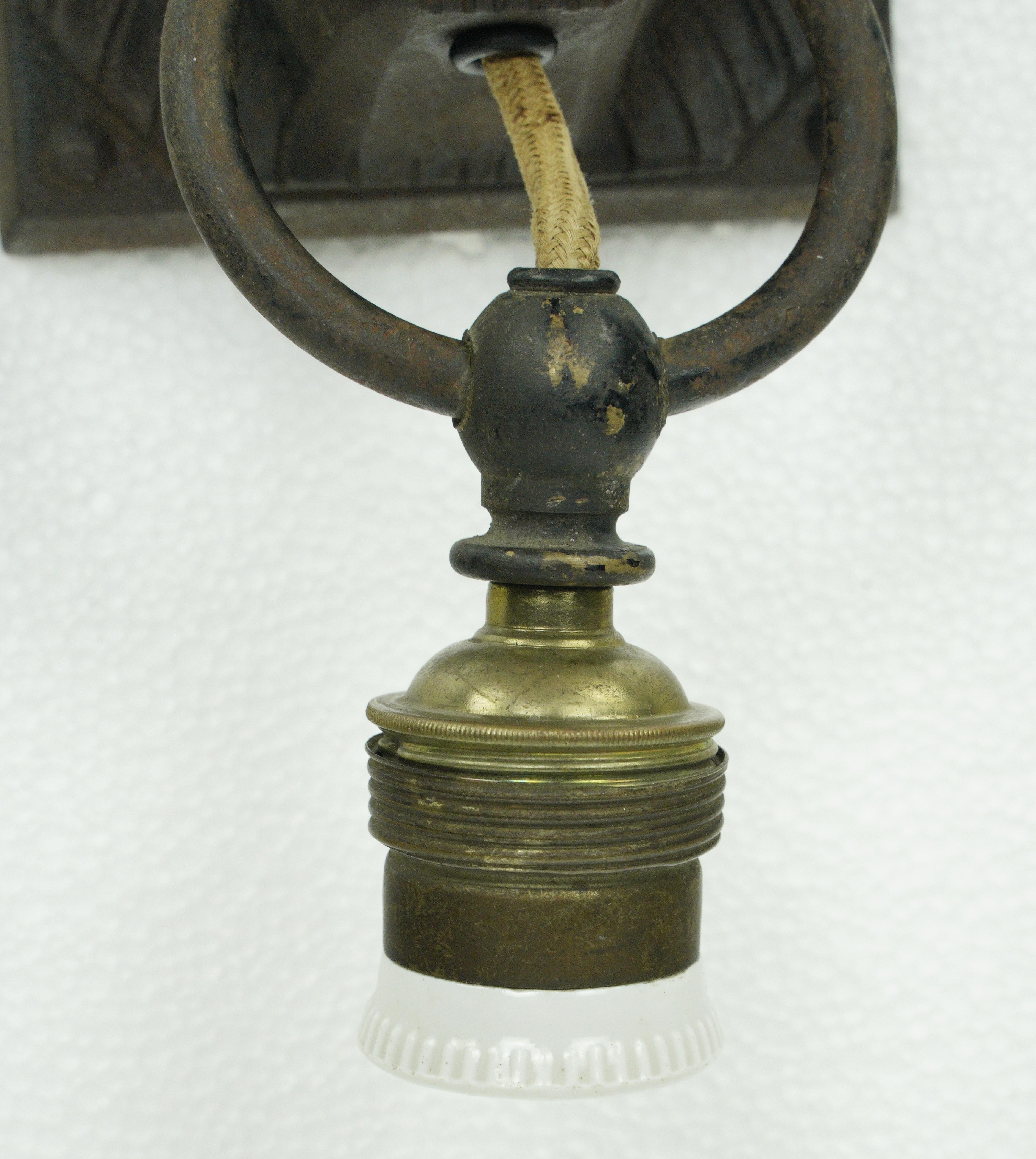 Black lion head wall sconce made of cast iron with a down light socket. This requires one standard medium base bulb. Good condition with appropriate wear from age. One available. Please note, this item is located in our Scranton, PA location.