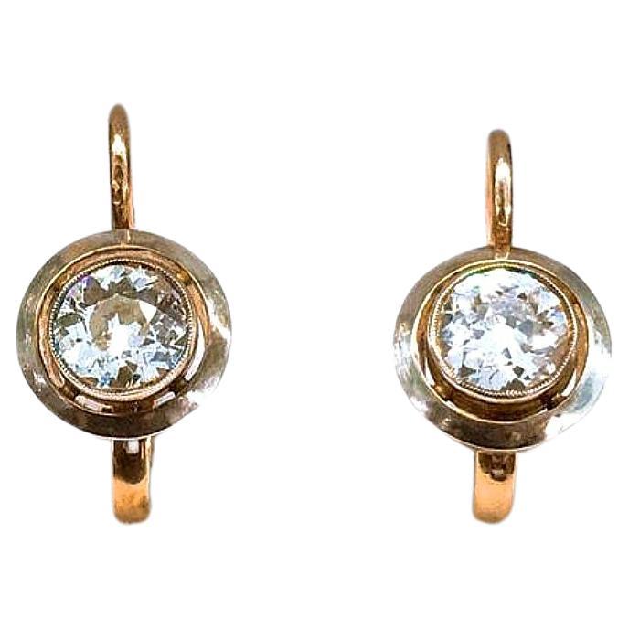 14k gold earrings centeted with 2 old mine cut diamonds with an estimate weight of 1 carat H color vs clearity in solitaire style earrings made of 14k gold hall marked 