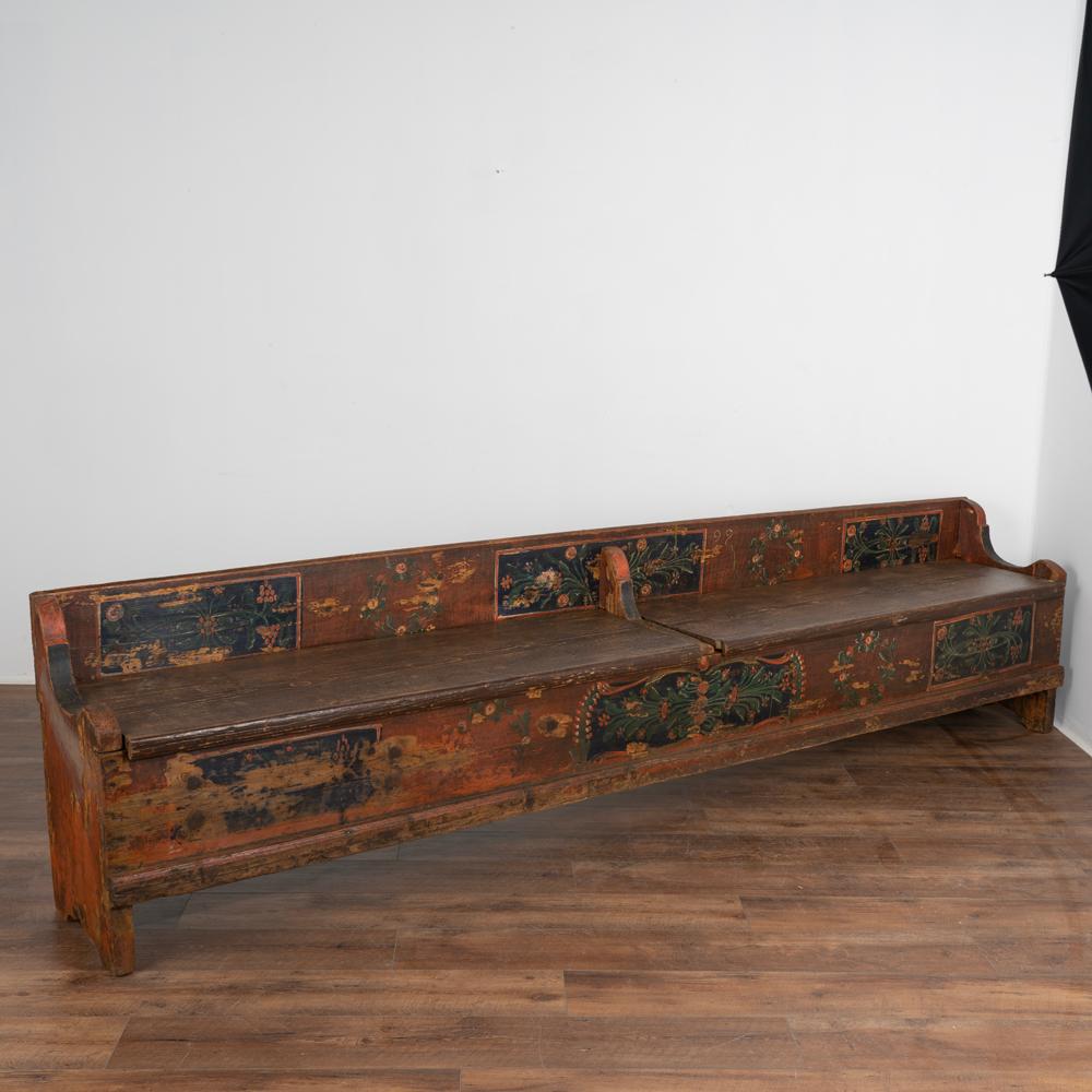 Antique hand painted bench with storage at almost 10' long .
Traditional Eastern European folk art painting with blue background and red, green and yellow florals.
Two bench seats open to reveal interior storage.
Restored, strong and stable. Can
