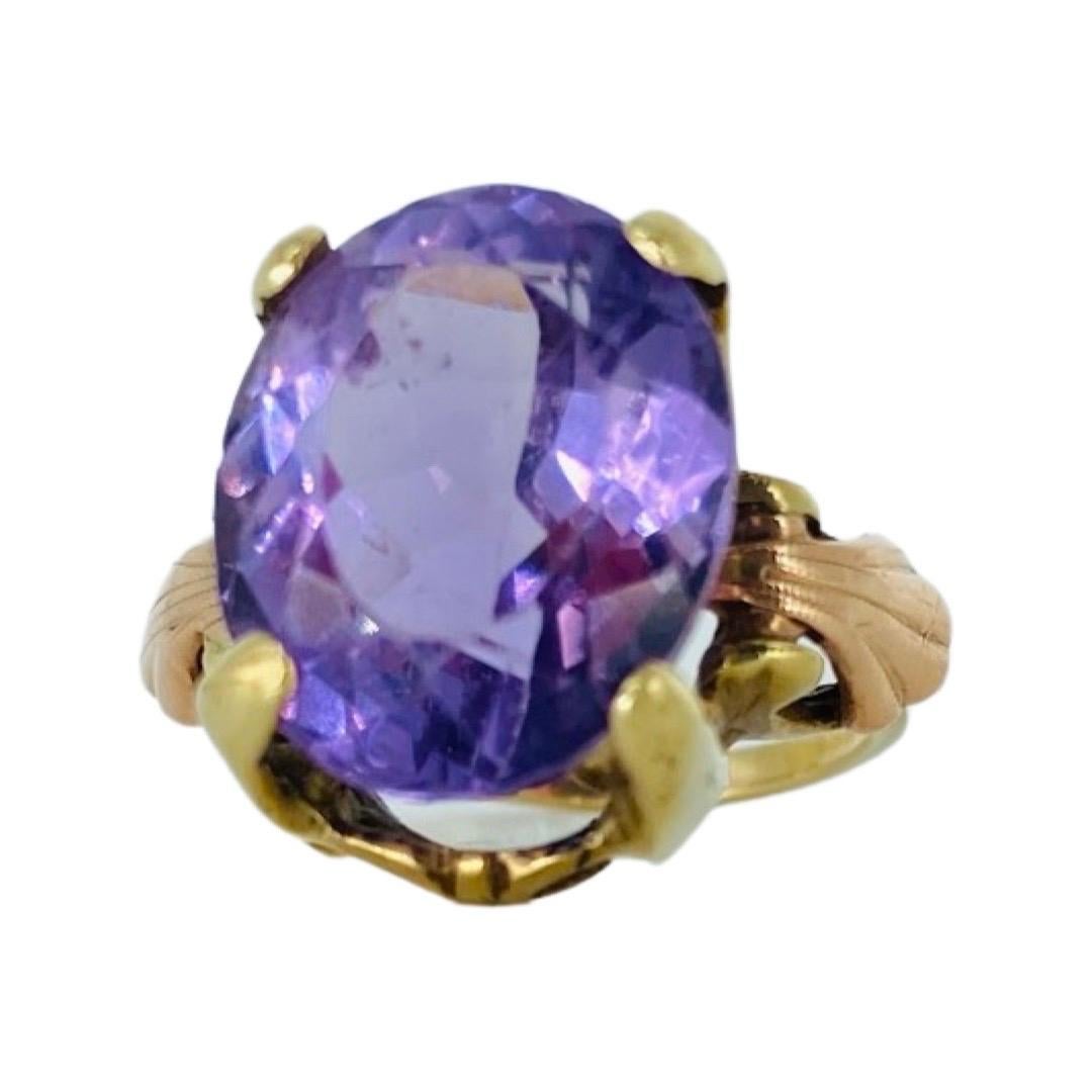 Antique 10.20 Carat Oval Amethyst Cocktail Ring. The Amethyst measures 15.40mm X 12.50mm X 10mm for a carat weight of 10.20 approx. the ring is made of 10 karat rose gold and yellow gold. The ring is a size 6.75 and weights 7.3 grams.
