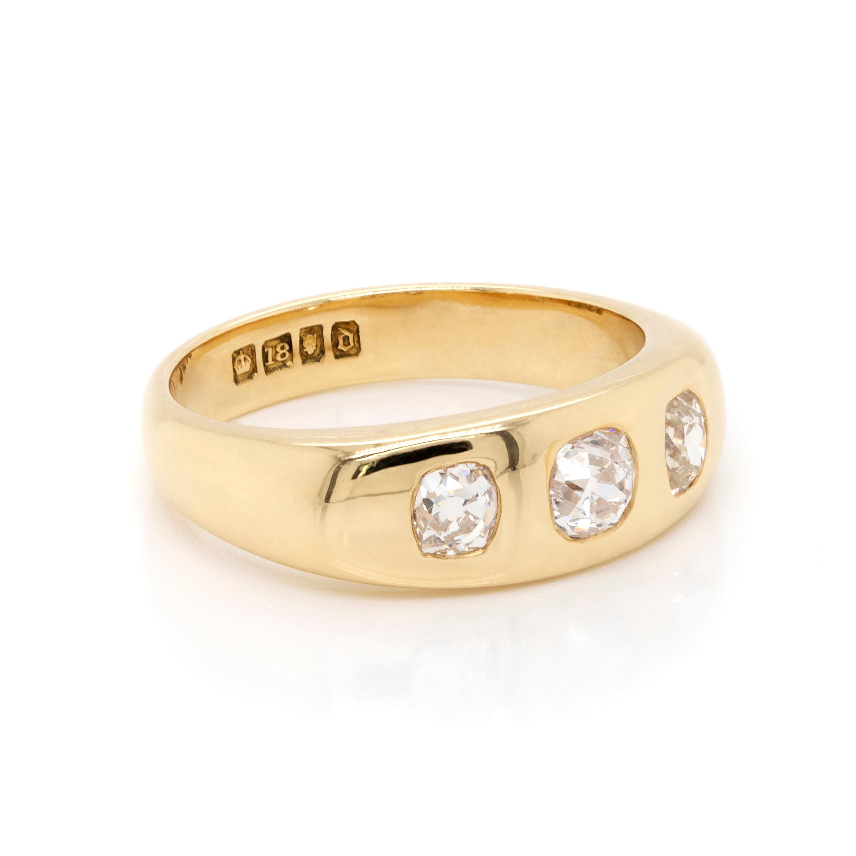 This beautiful antique gents ring, dating from 1919, features three old mine cut diamonds with a total carat weight of 1.04 carats, all mounted in 18 carat yellow gold rub-over settings. Hallmarked 18. England, 1919. UK finger size 'O'.