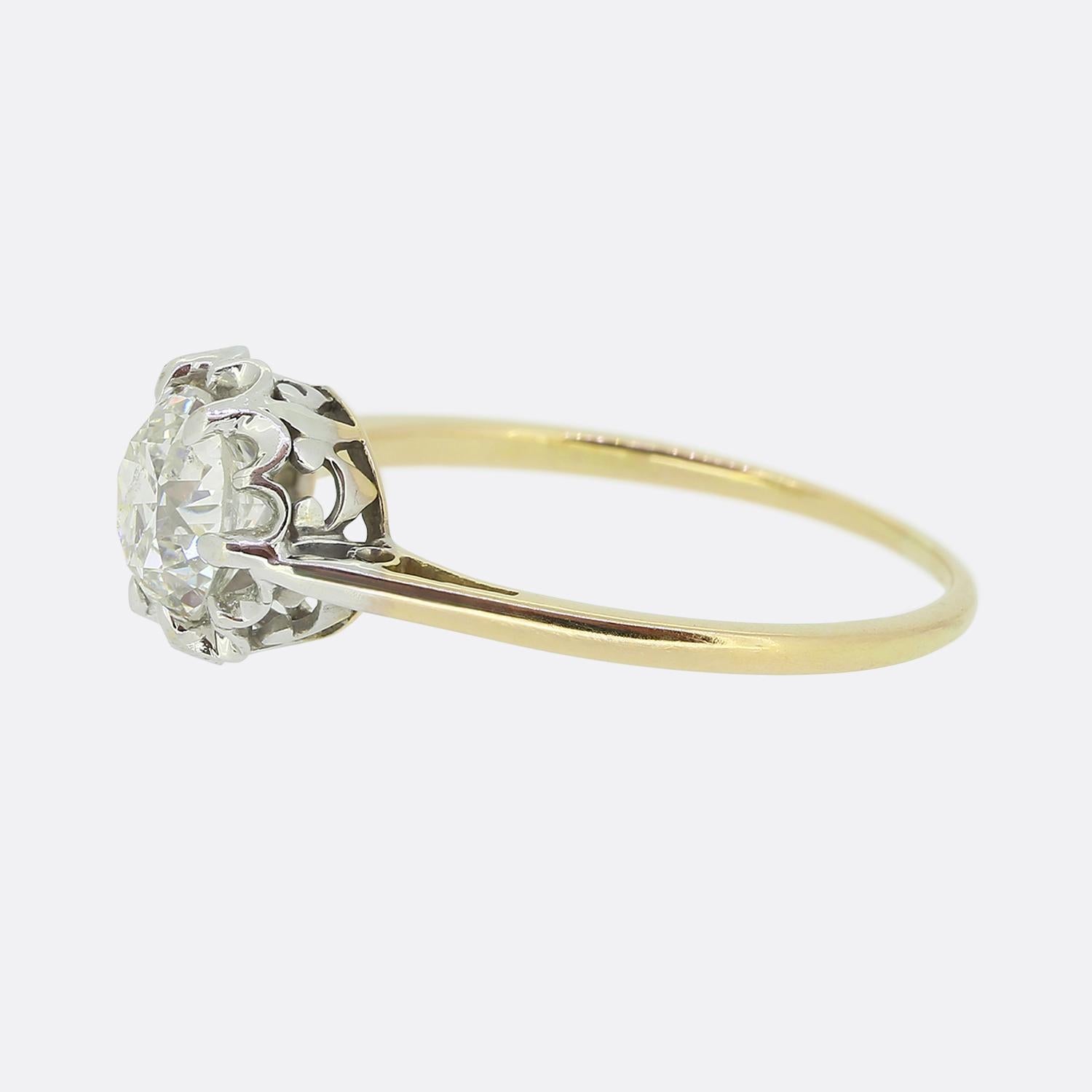 Here we have a gorgeous antique diamond solitaire ring. This piece showcases a scintillating bright white round faceted old European cut diamond which sits alone and proud in an 8 clawed platinum setting atop an ornately pierced under-gallery and
