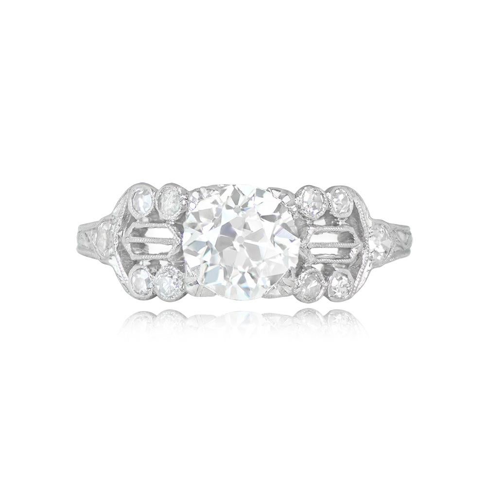 This Art Deco engagement ring showcases a vibrant 1.06-carat old European cut diamond held by prongs. The central diamond is graded I color and VS2 clarity. The ring's shoulders boast intricate openwork filigree and single-cut diamonds. Its platinum