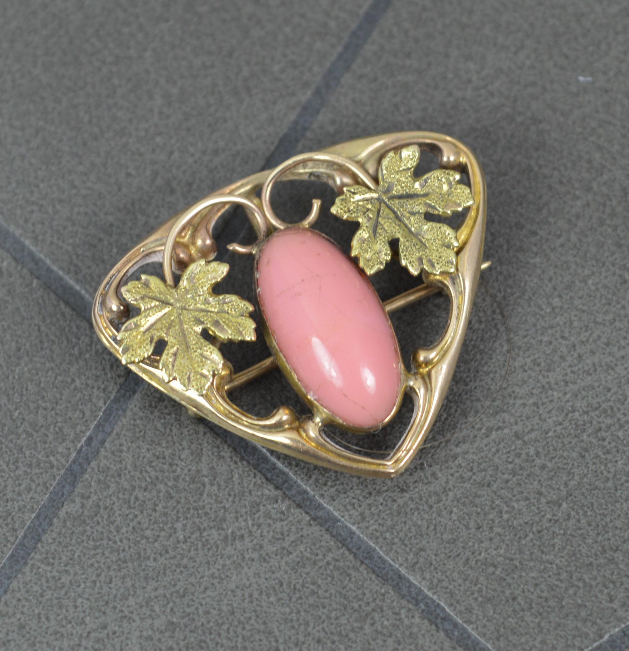 A beautiful true antique brooch circa 1900.
10 carat gold bar brooch.
Set with an oval shaped coral to centre with an engraved leaf to each side and a triangular shape.
2.9 grams, 27mm x 23mm approx

Condition ; Excellent. Crisp design and well set
