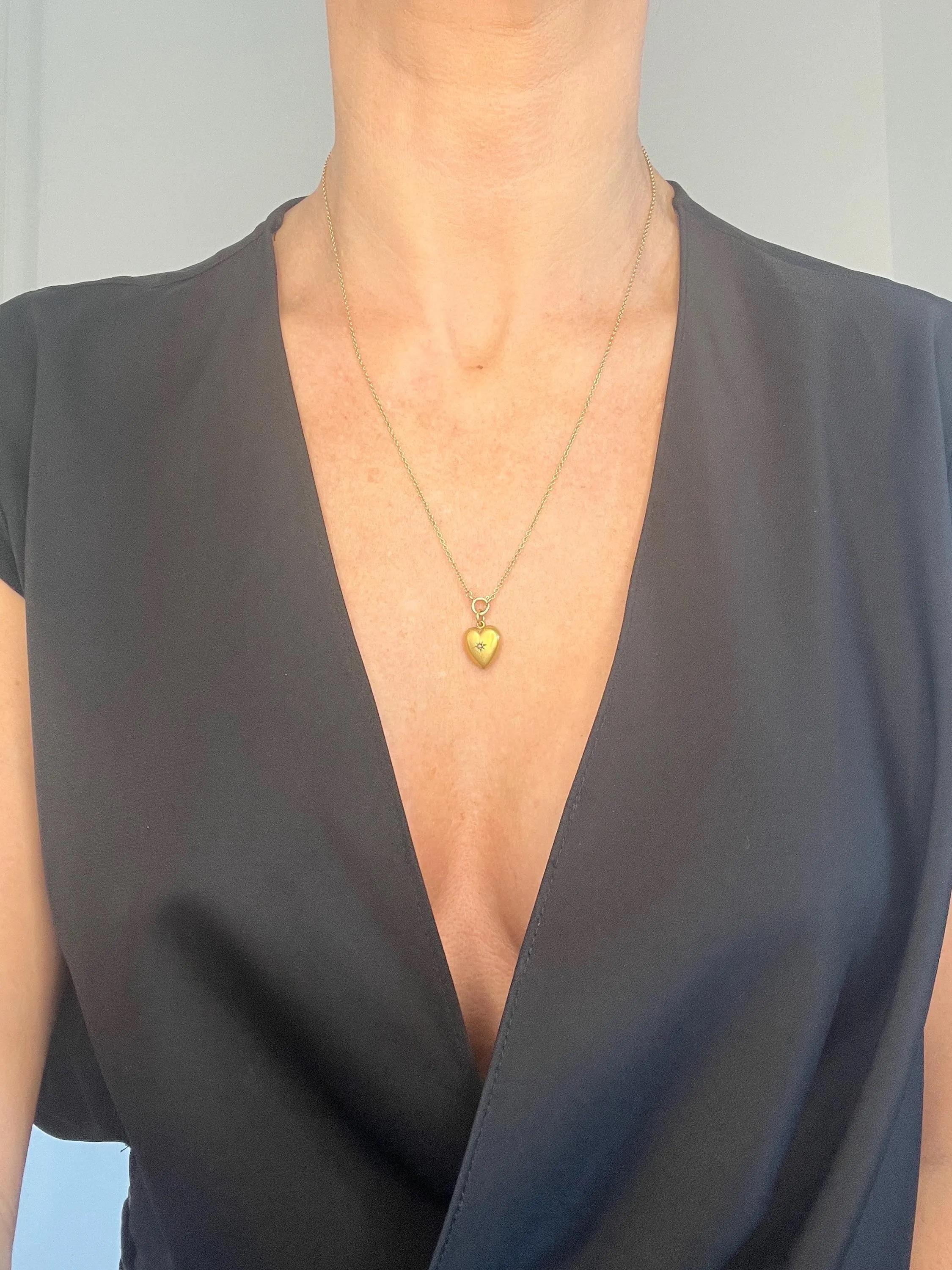 Antique Heart Pendant 

10ct Gold Stamped 

Circa 1880s

* THE CHAIN IS SOLD SEPARATELY 

This exquisite Victorian heart pendant, crafted from a matt-finished 10ct yellow gold, beautifully embodies the essence of love. The charm features a stunning