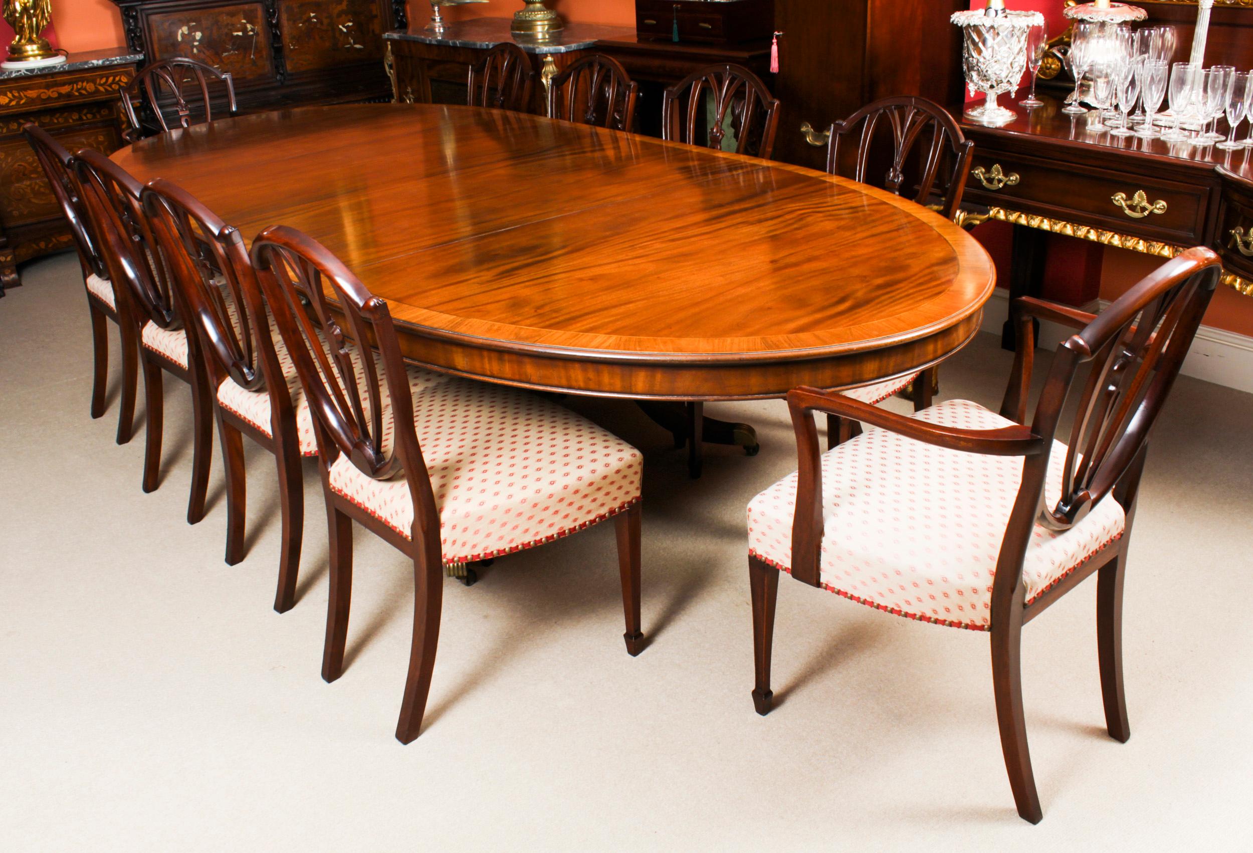 This is a fabulous antique Regency Revival oval flame mahogany extending dining table, circa 1920 in date. 
 
The oval table been hand-crafted from flame mahogany with crossbanded decoration, and has two original leaves.
 
The two leaves can be
