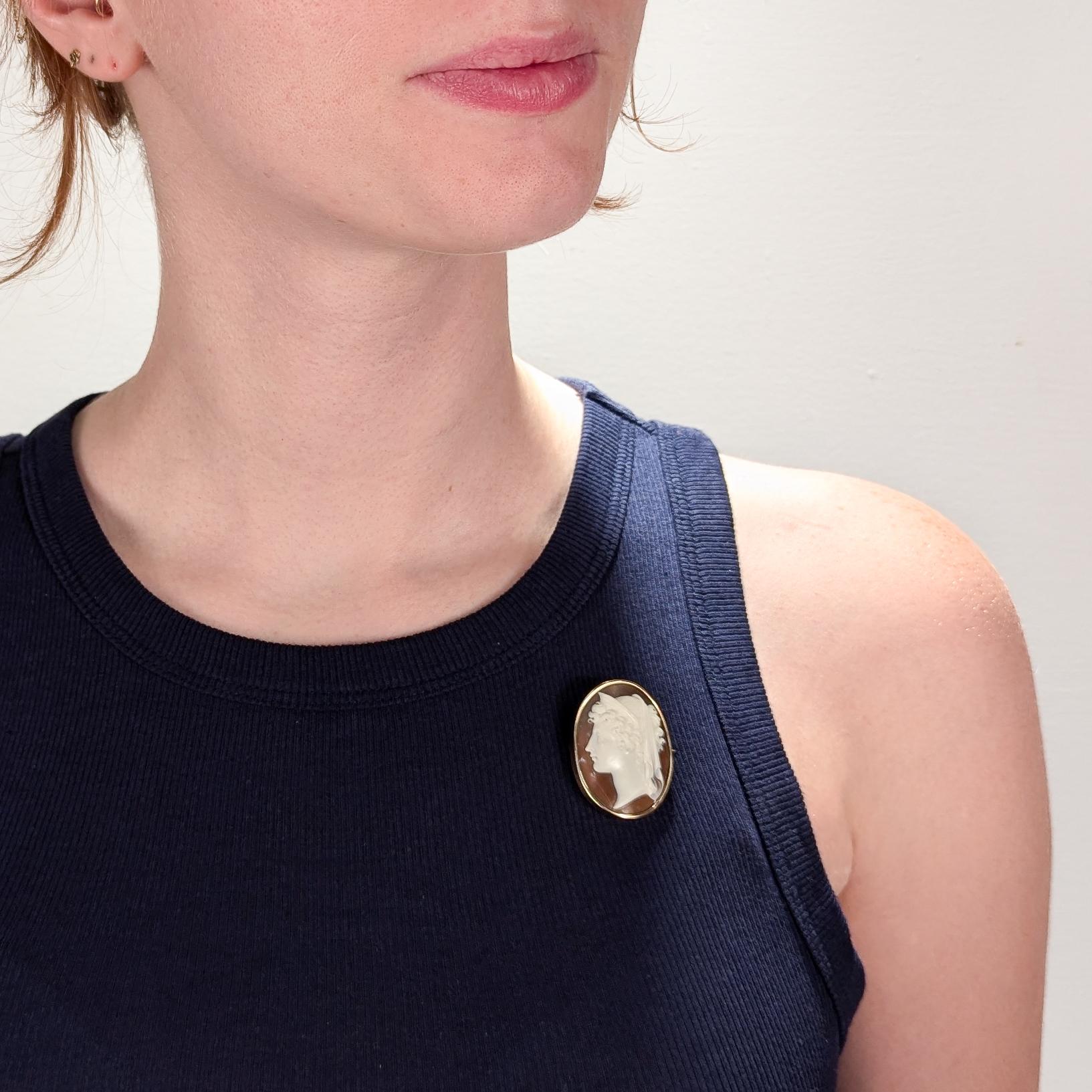 A fine antique carved shell cameo brooch.

In a 10K gold mount.

With a bezel-set, carved shell cameo of the Greek goddess Hera, the goddess of women, marriage, and childbirth. (Known by Romans as Juno.)

Set with an elongated pin and a c-shaped