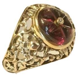 Antique victorian garnet ring in open work style centered with engraved garnet stone topped with a rose cut diamond with total gold weight of 4 grams hall marked 375 for 10k gold and victorian assay mark and initial maker mark