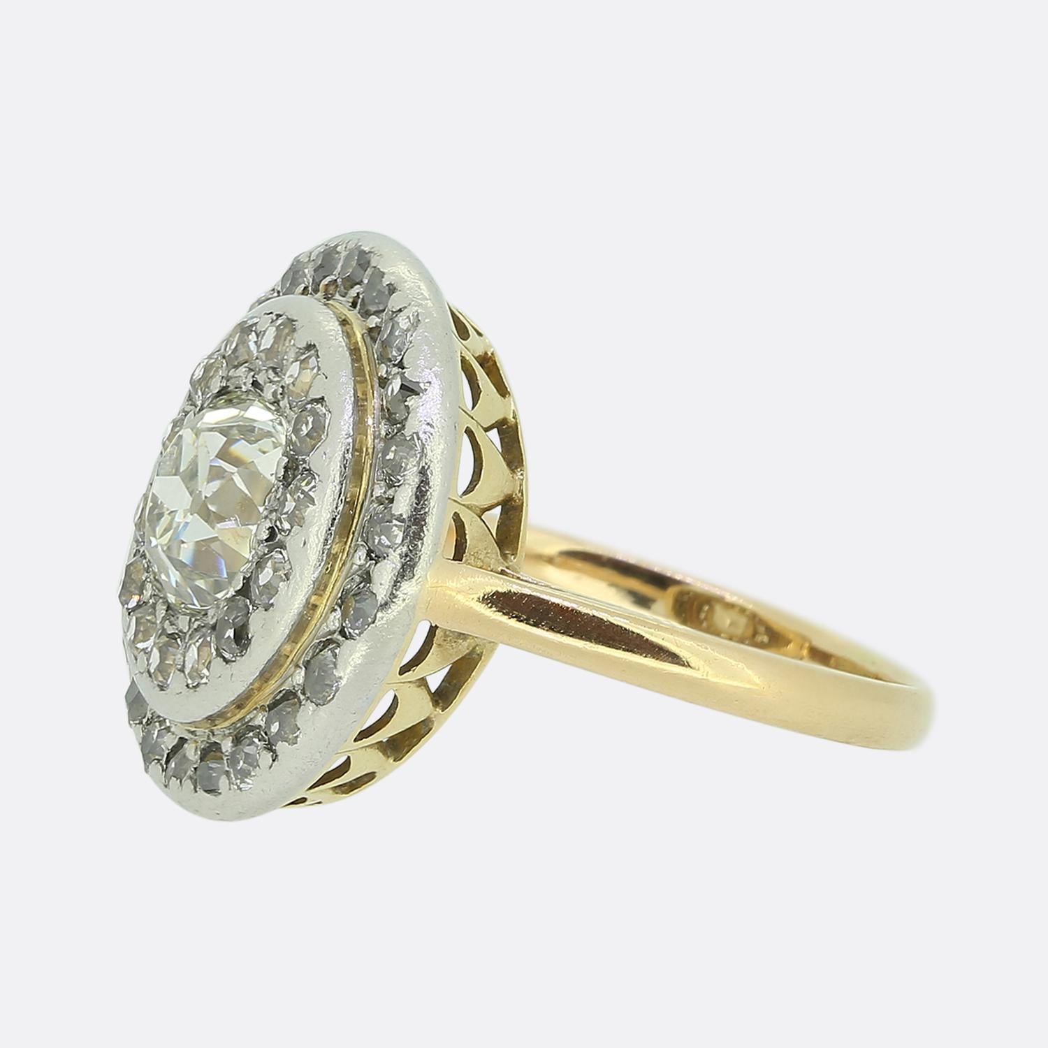 Here we have an outstanding diamond cluster ring dating back to the early stages of the 20th century. Taking centre stage is a remarkable 1.10ct old cushion cut diamond which sits slightly risen amidst a double halo of chunky round faceted old cut