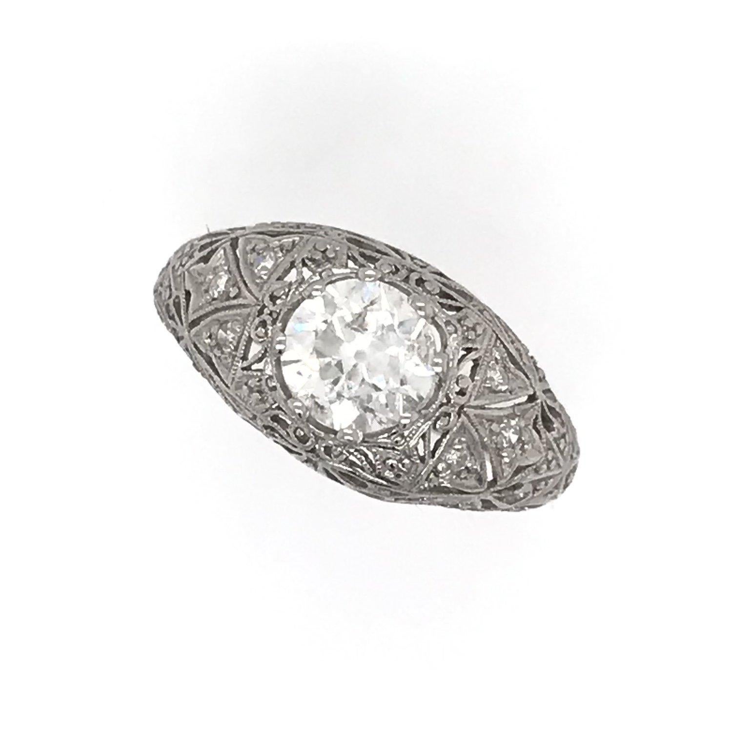 This antique piece was handcrafted sometime during the early twentieth century ( 1910-1940 ). At some point in time the platinum setting was completely re-shanked with a wider comfort fit style band. The center diamond measures approximately 1.15