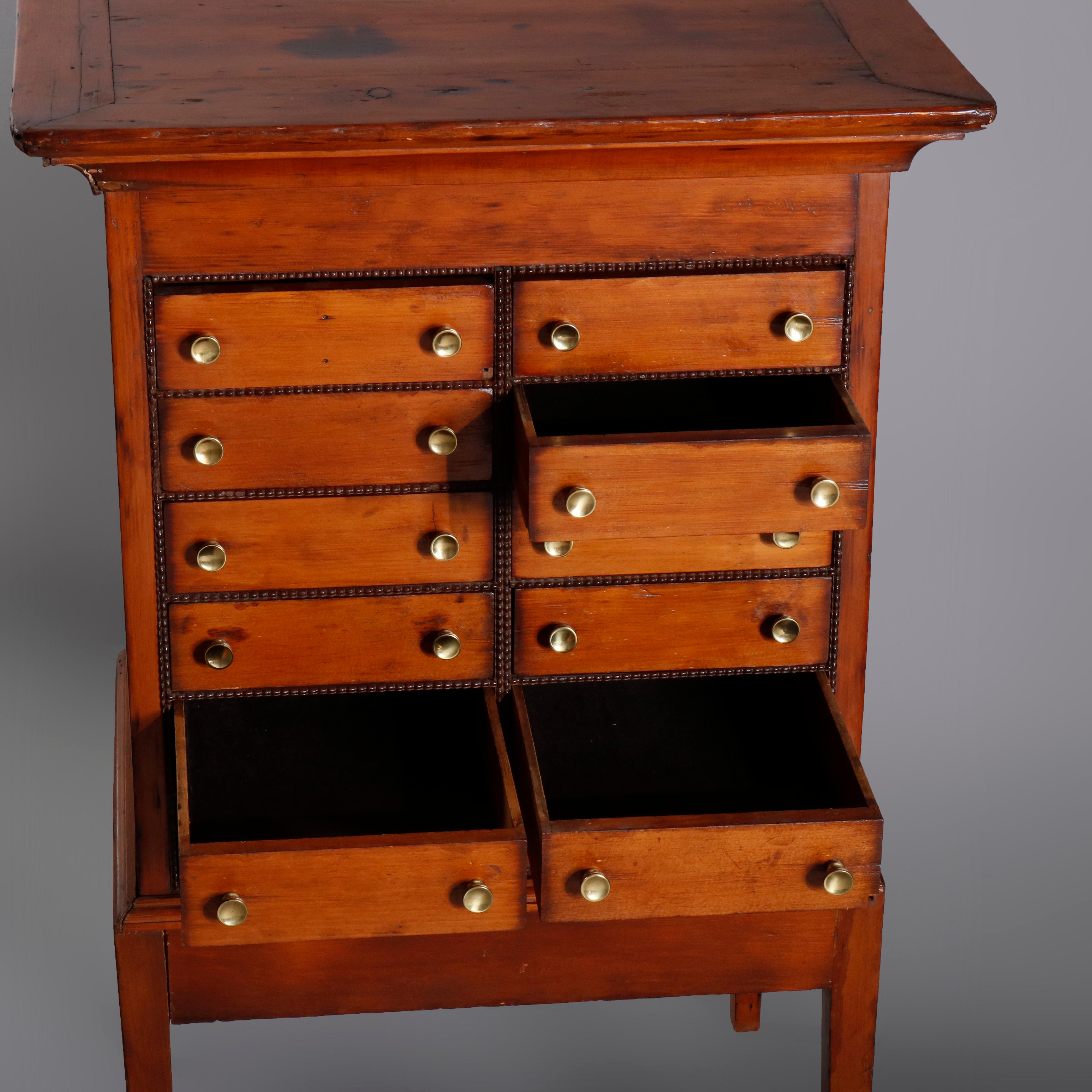 An antique apothecary specimen cabinet offers flared crest surmounting double tower having 12 drawers, some segmented, raised on base with straight legs, circa 1870

 Measures: 37