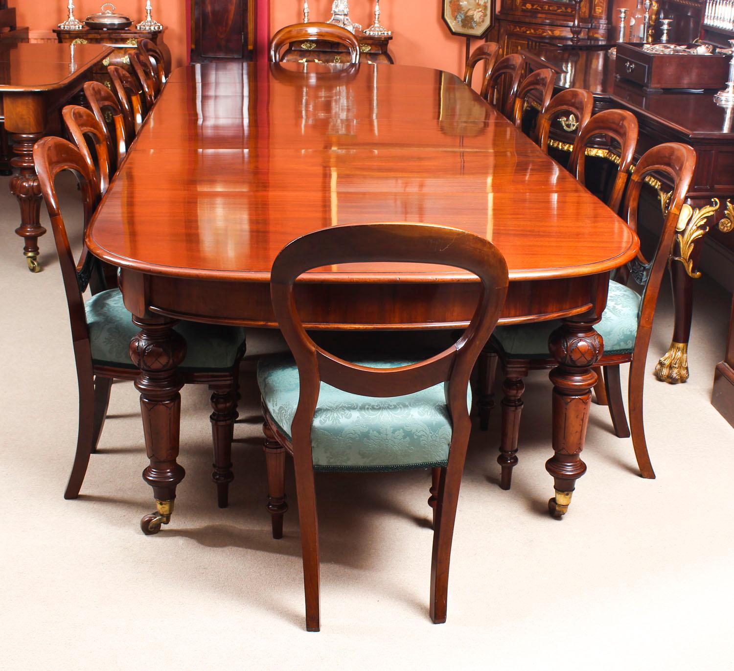 This is a fabulous dining set comprising an antique Victorian solid mahogany D-end dining table with a set of fourteen antique upholstered back dining chairs, all circa 1870 in date.

The beautiful table is in stunning flame mahogany and has four