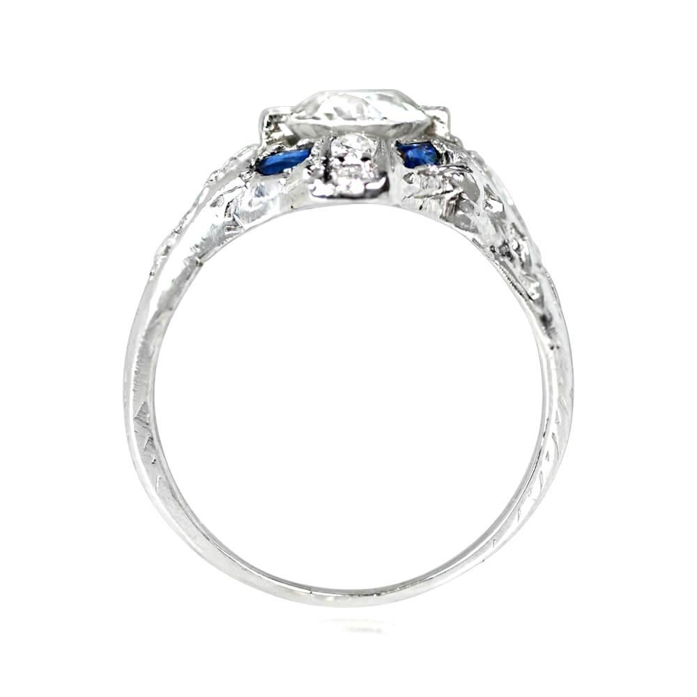 An exquisite Art Deco diamond and sapphire engagement ring, featuring a 1.22 carat old European cut diamond, I color and VS1 clarity, surrounded by French cut sapphires and single cut diamonds. The platinum mounting is embellished with