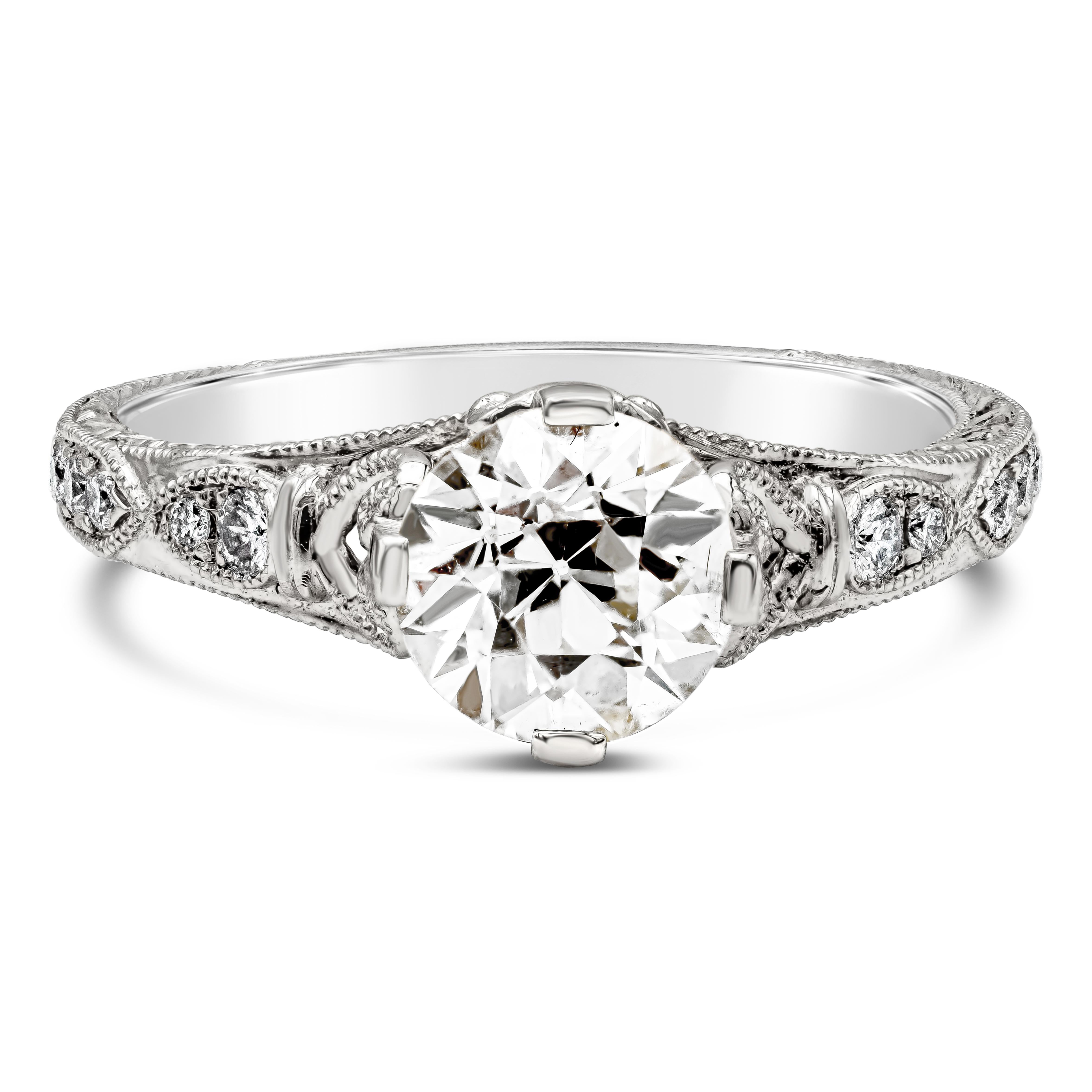 An vintage engagement ring showcasing a 1.24 carats old European cut diamond set in a compass point setting made in platinum. Accented with round brilliant diamonds set flushed in an art deco style on either side. Finished with milgrain edges for a