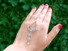 Antique 1.29ct Diamond and Pearl Platinum Bow Pendant, circa 1900