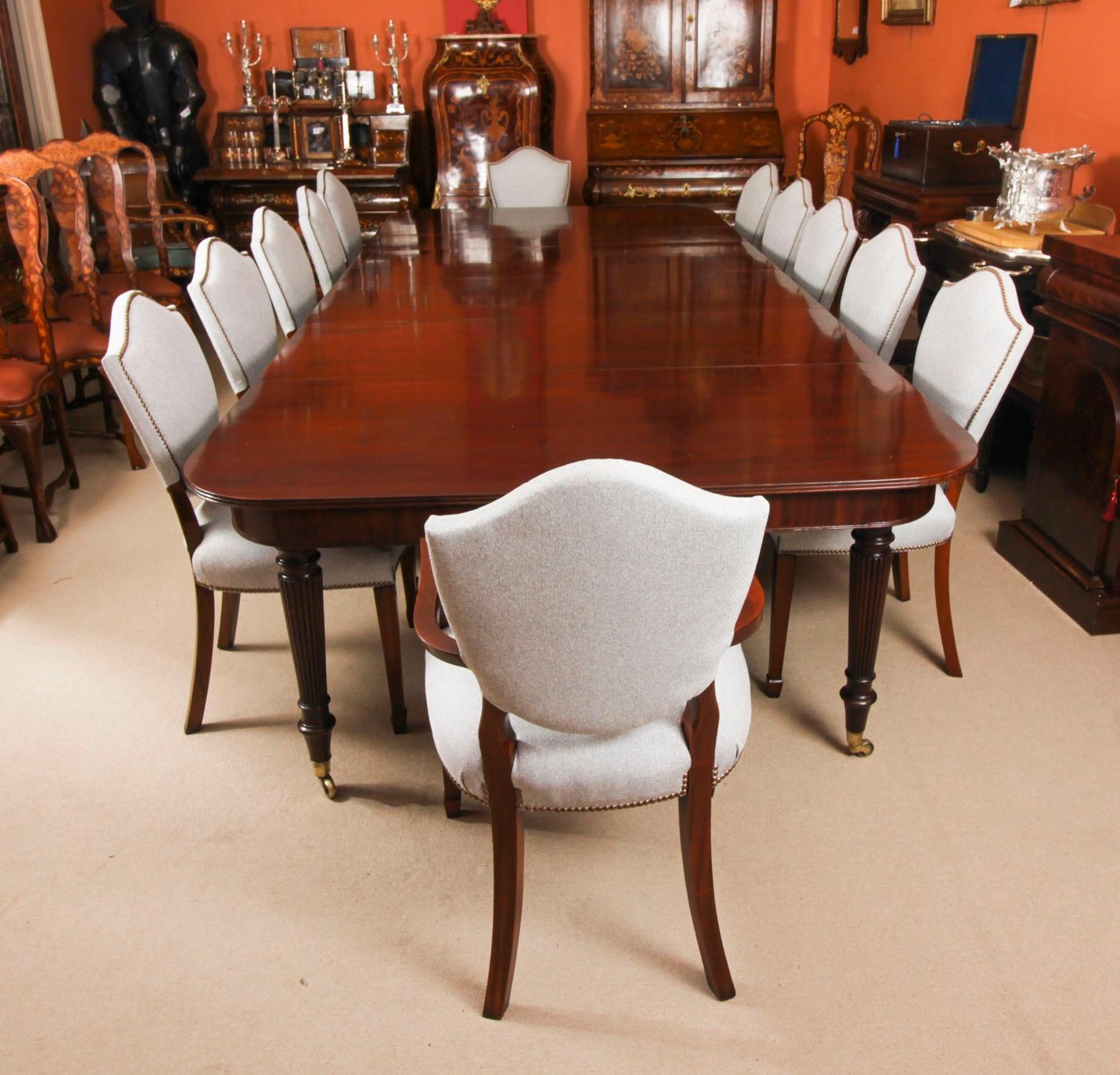 A very rare opportunity to own a fabulous dining set comprising an antique George III flame mahogany Imperial style  extending  dining table in the manner of Gillows of Lancaster, with a Vintage set of 12  Regency Revival Bar Back dining