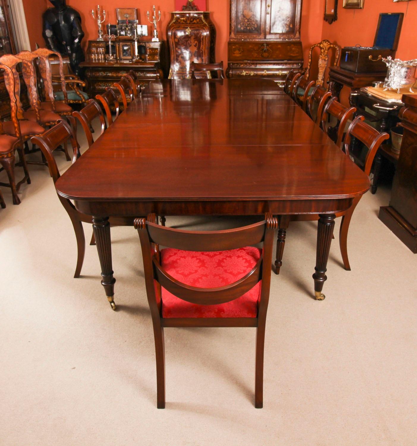 A very rare opportunity to own a fabulous dining set comprising an antique George III flame mahogany Imperial style extending  dining table in the manner of Gillows of Lancaster, with a Vintage set of 12  Regency Revival Swag Back dining