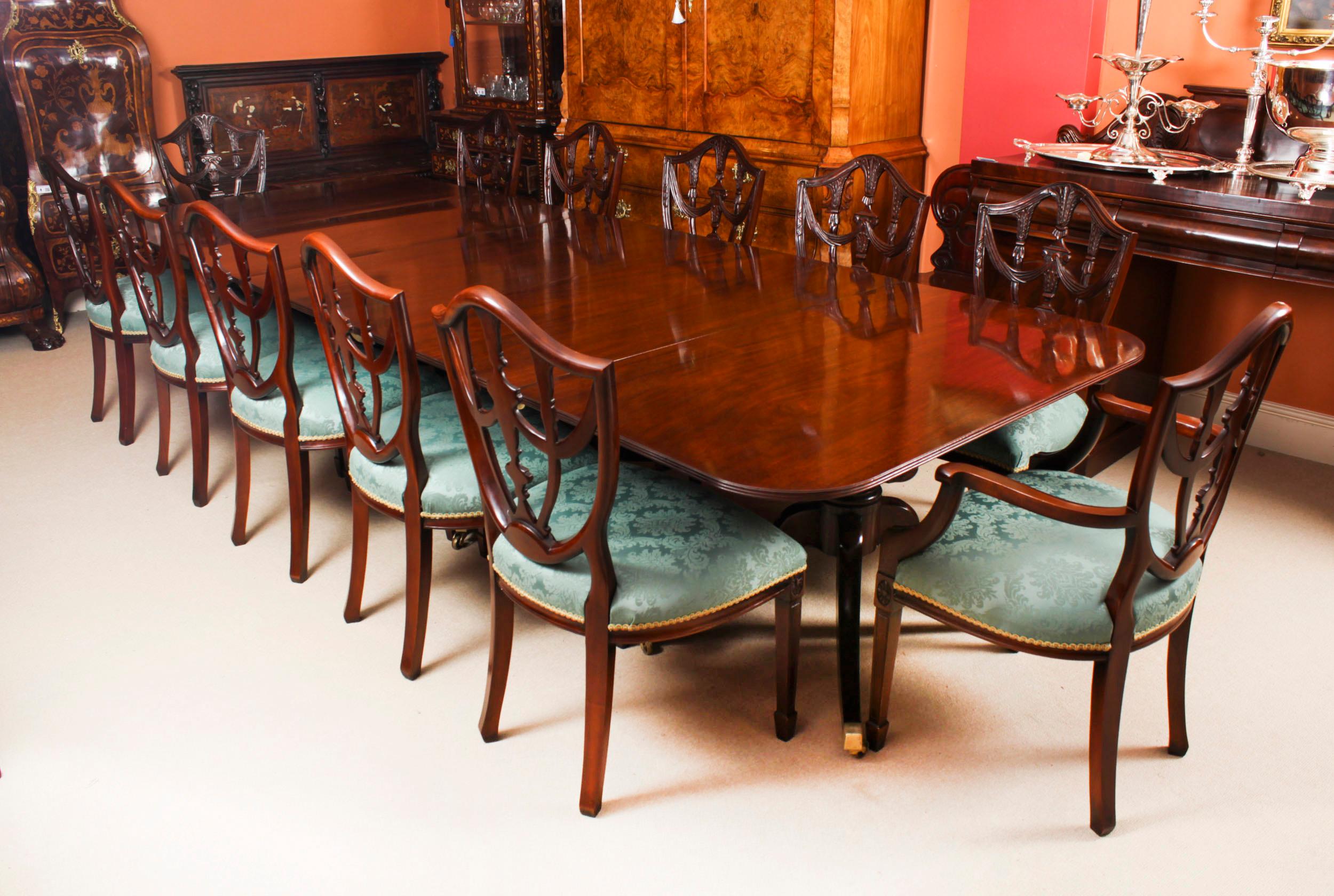 This is an elegant antique Regency dining table that can comfortable seat twelve people, circa 1830 in date.

The table features elegant simplicity, with straight, unbroken surfaces and lines.  It has two leaves which can be added or removed as