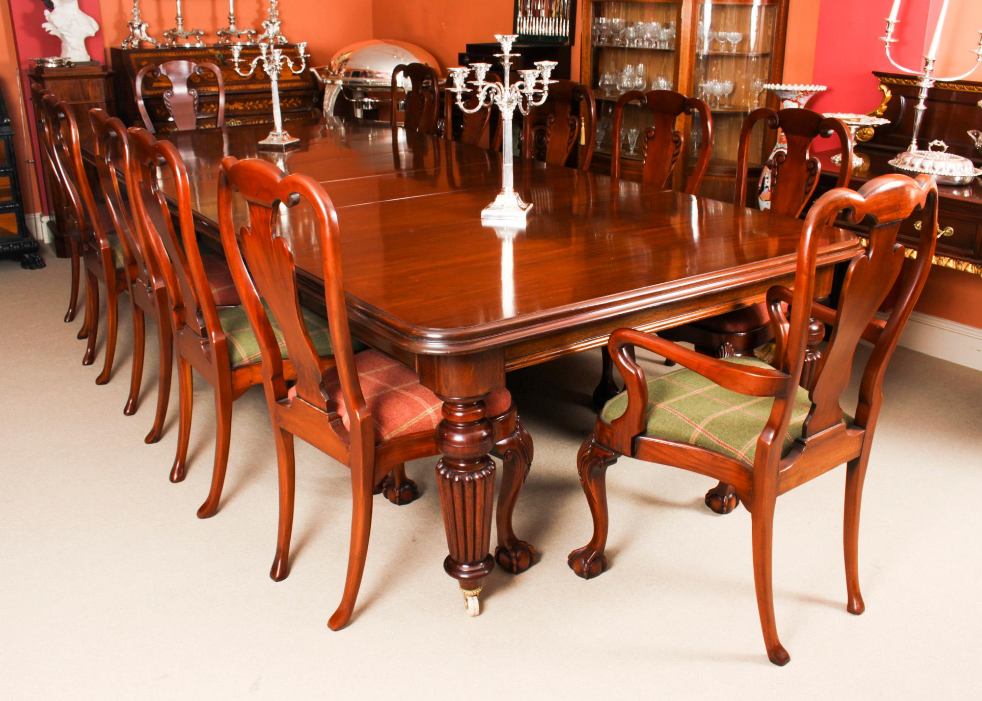 This is a rare opportunity to own an antique early Victorian, flame mahogany dining or conference table, circa 1850 in date and a set of twelve vintage Queen Anne Revival dining chairs, dating from the mid 20th Century.

The superb dining table has