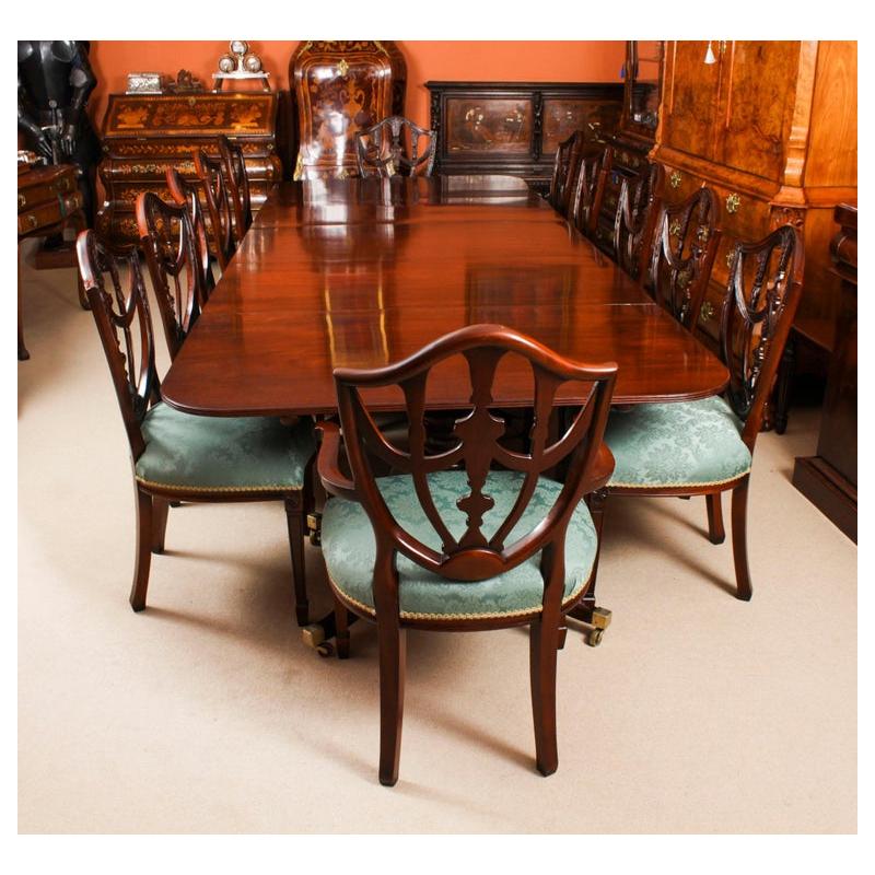 This is an elegant antique Regency dining table that can comfortable seat twelve people, circa 1830 in date.

The table features elegant simplicity, with straight, unbroken surfaces and lines.  It has two leaves which can be added or removed as