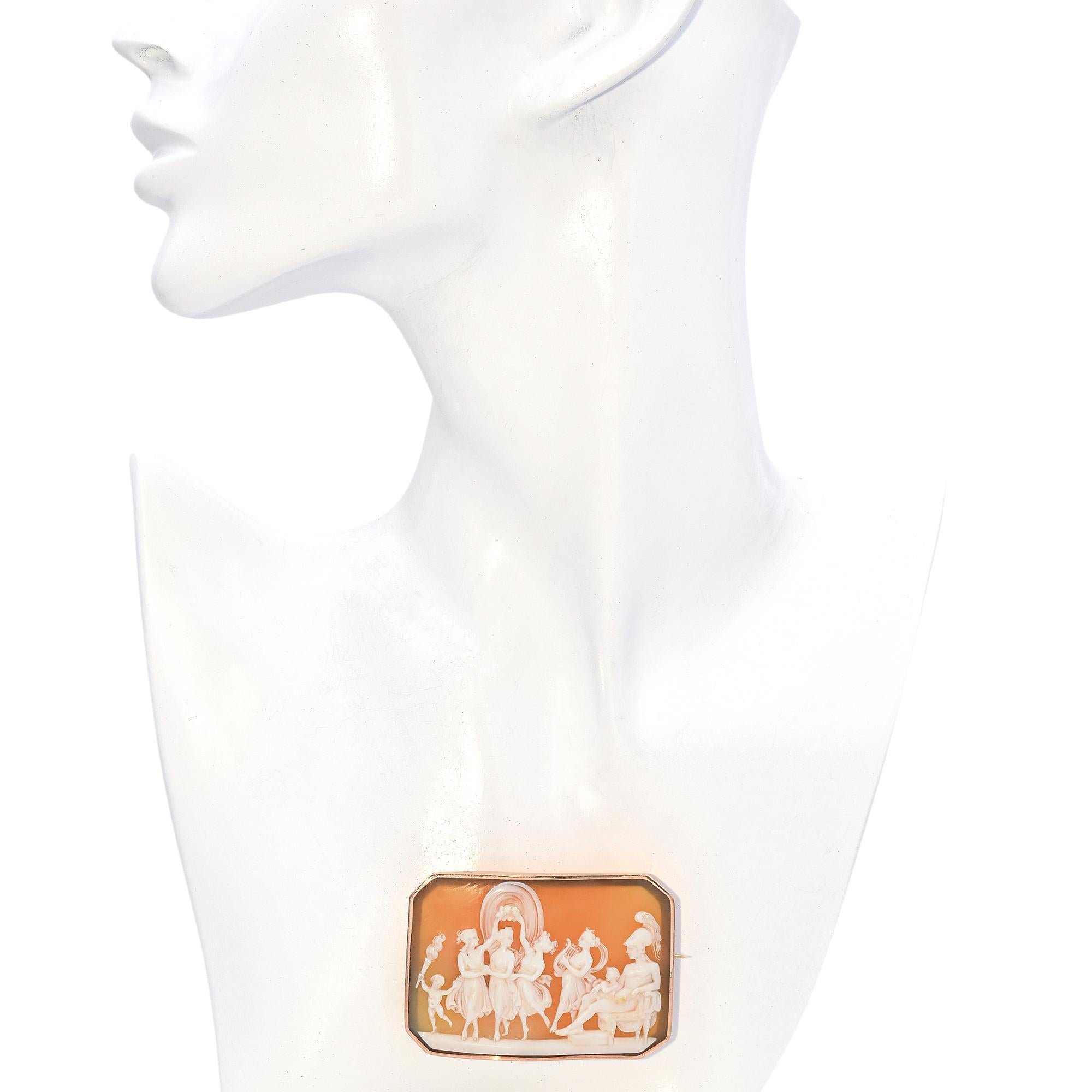 Crafted in 12k rose gold, this brooch showcases a detailed depiction of a classical scene, Mars, Venus and three Graces, all set against a warm background.
The rectangular frame, with softly beveled edges, enhances the elegance of the piece,