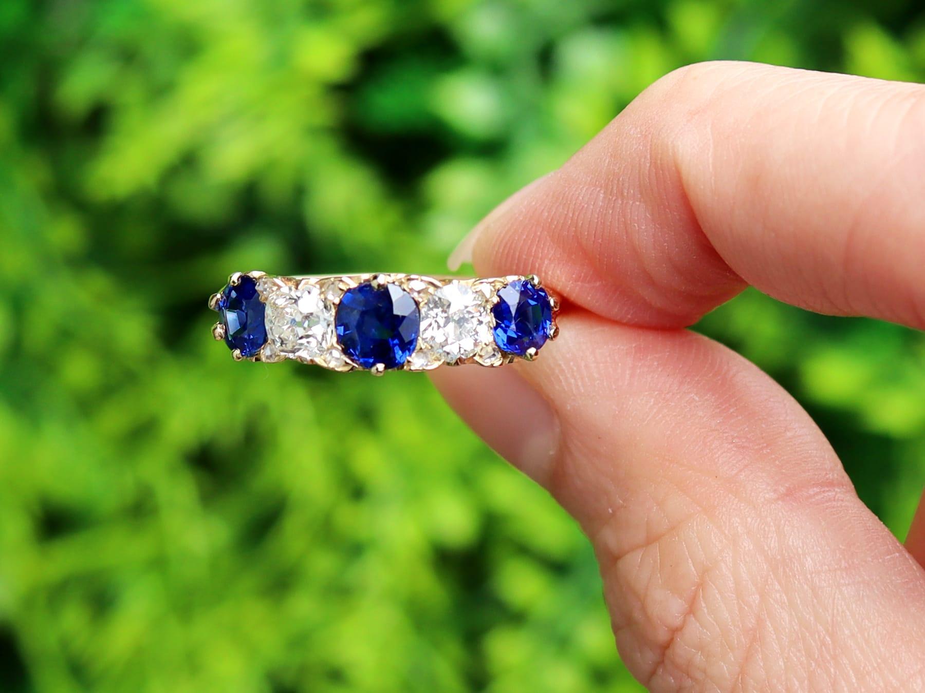 A stunning, fine and impressive antique 1.30 carat blue sapphire and 1.08 carat diamond, 18 karat yellow gold ring; part of our diverse collection of five stone rings.

This stunning, fine and impressive sapphire and diamond ring has been crafted in