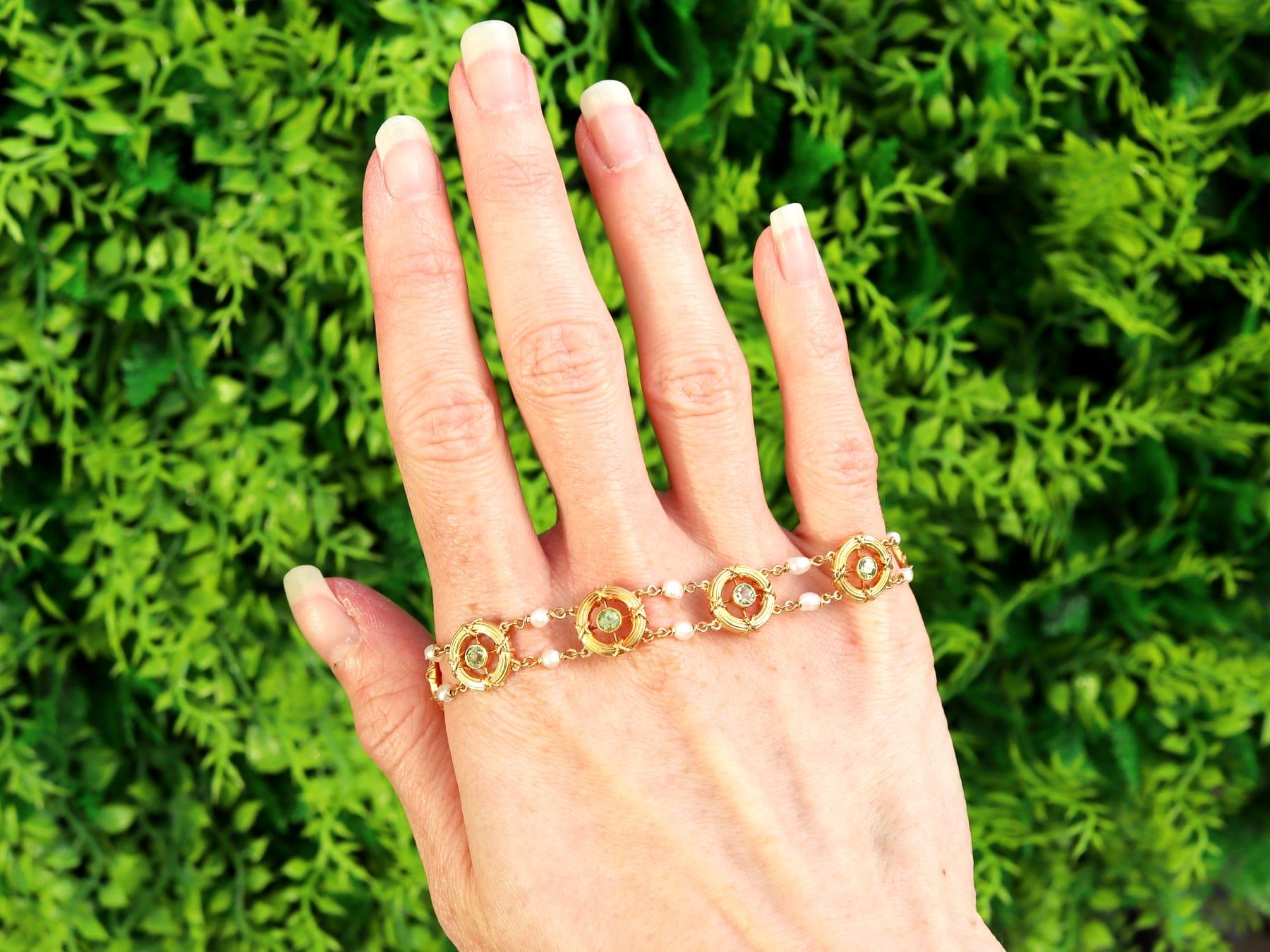 A stunning, fine and impressive antique peridot, natural pearl and 15 karat yellow gold bracelet; part of our diverse antique peridot jewelry and estate jewelry collections.

This stunning, fine and impressive antique bracelet has been crafted in