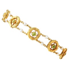 Antico bracciale in oro giallo CIRCA 1900, con perle naturali e peridoto da 1,35 ct.