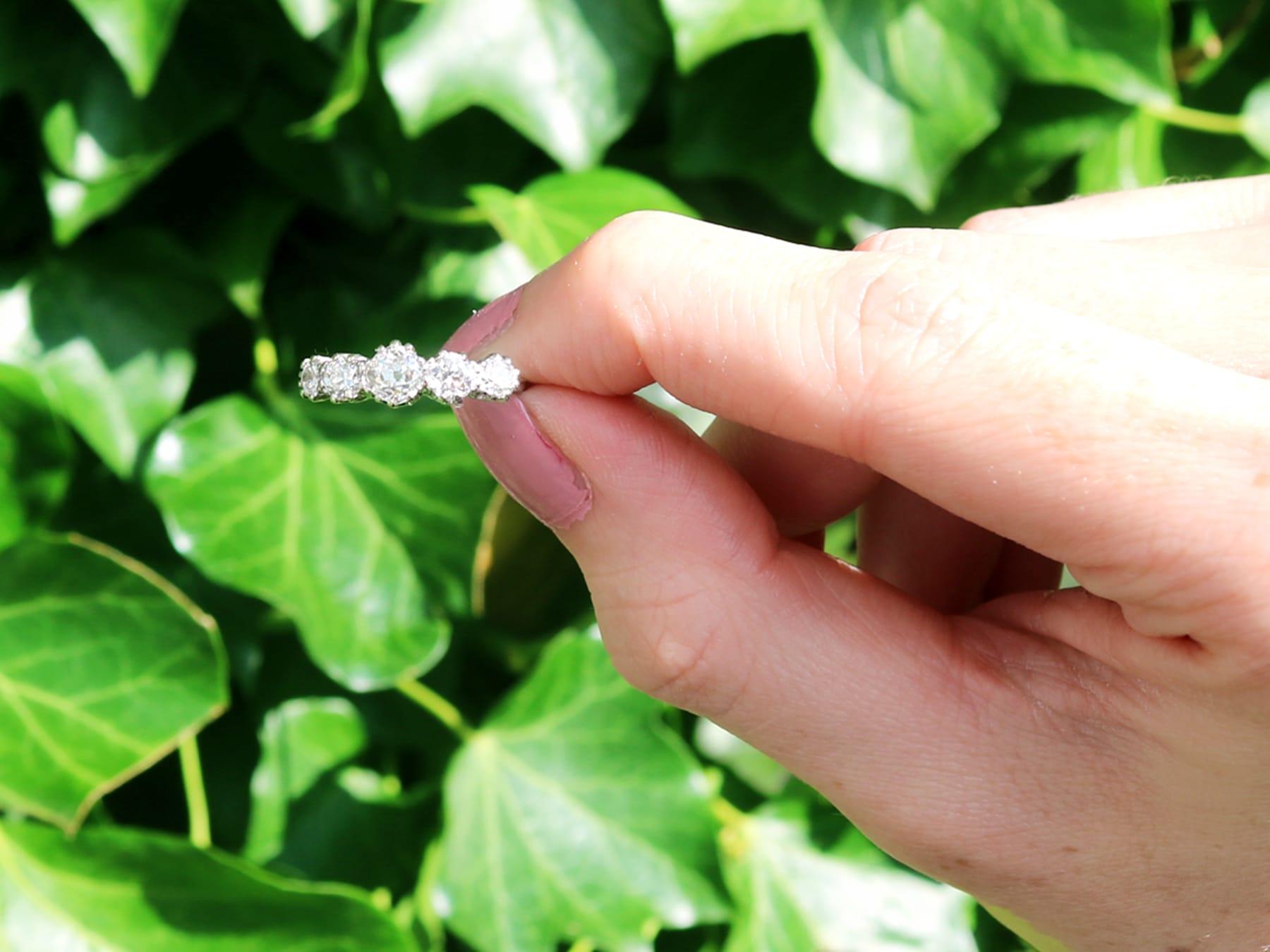 A fine and impressive antique 1.37 carat diamond and 18 karat white gold, platinum set five stone dress ring; part of our diverse antique jewelry and estate jewelry collections.

This fine and impressive five stone diamond ring has been crafted in