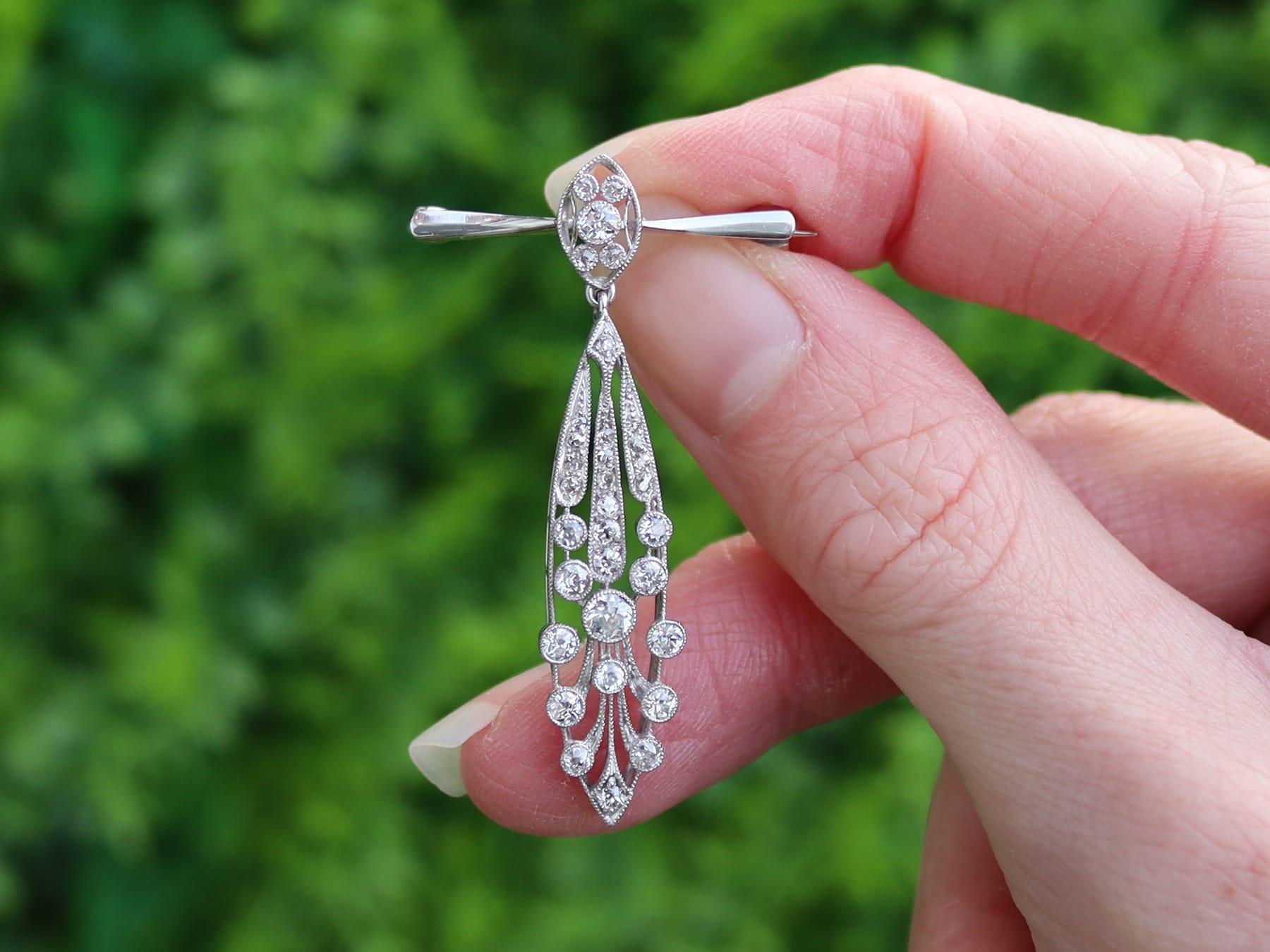 A fine and impressive antique 1920's 1.38 carat diamond, platinum and 15 karat white gold drop brooch; part of our diverse antique 1920s diamond jewelry collections.

This fine and impressive antique diamond lapel brooch has been crafted in platinum