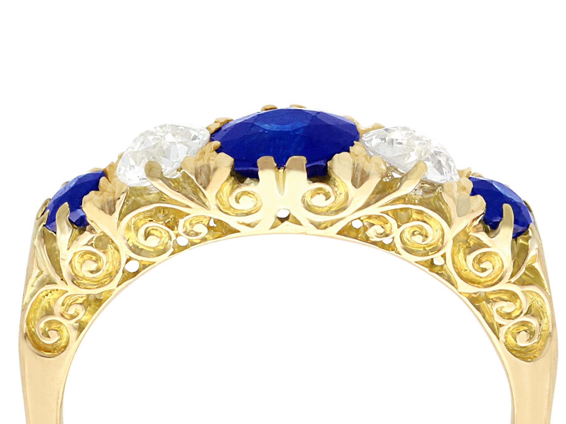 A stunning, fine and impressive antique 1.39 carat natural blue sapphire and 0.72 carat diamond, 18 karat yellow gold, five stone ring; part of our antique jewelry and estate jewelry collections.

This stunning antique sapphire and diamond ring has