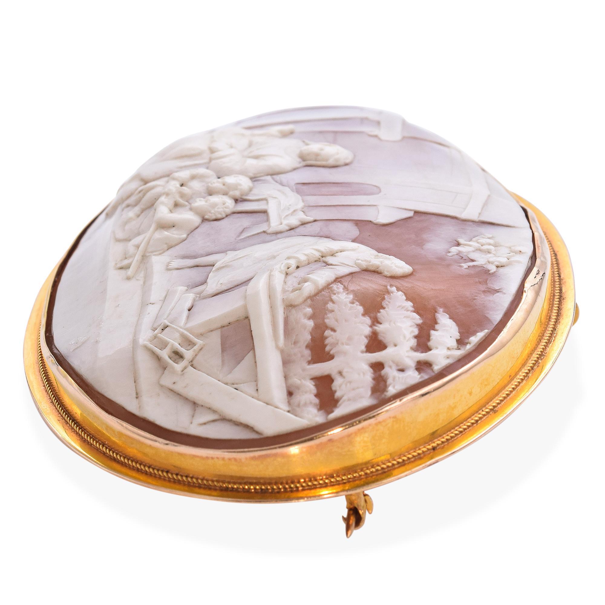 This antique yellow gold cameo brooch features a finely detailed carving of Mary, Jesus, John the Baptist, and Joseph engaged in a tender carpentry scene. The figures are depicted with grace and depth, capturing a rare moment of daily life within