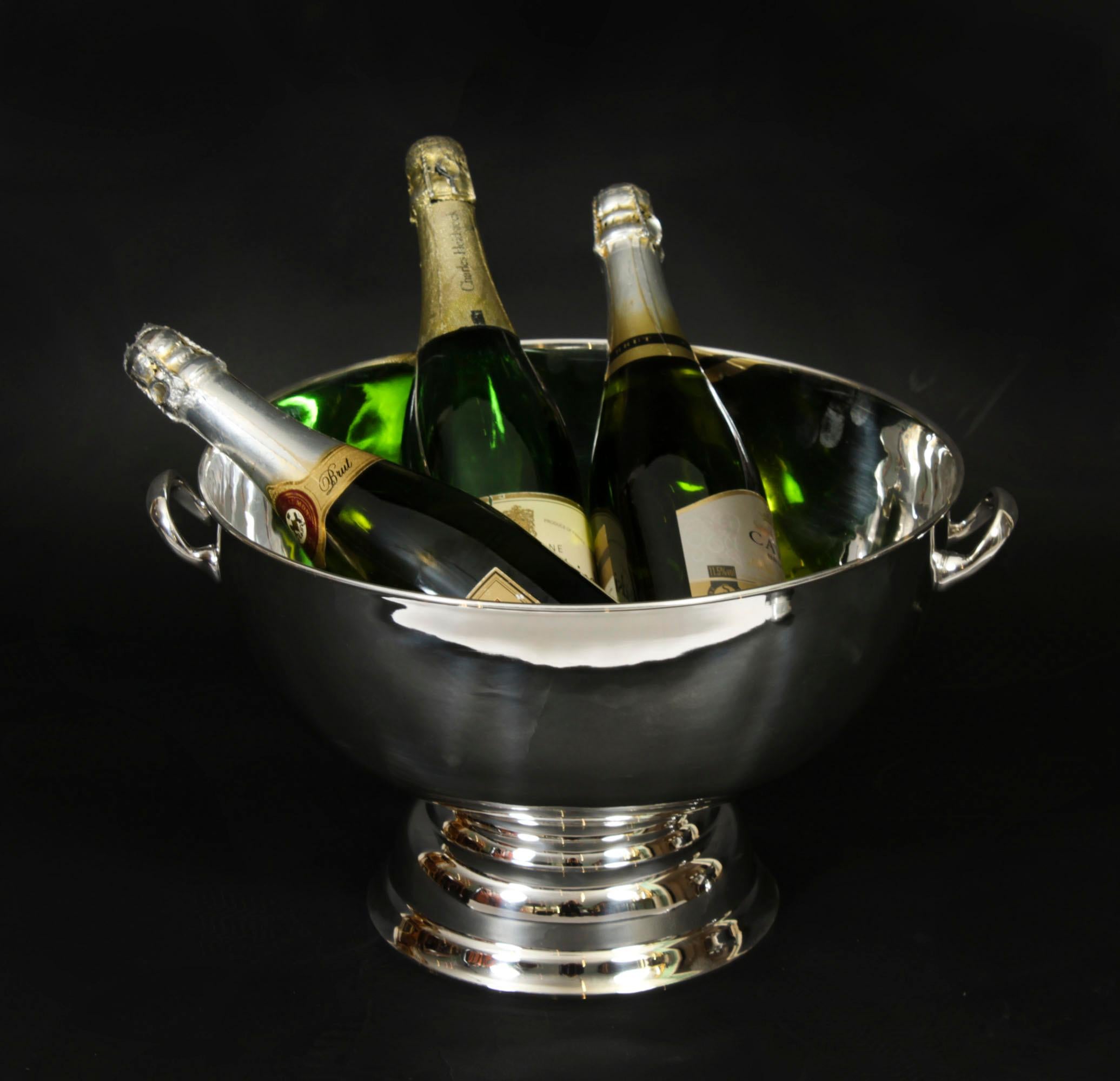 This is a elegant large Art Deco silver plate on copper wine / champagne  cooler bearing the makers mark of the renowned silversmith,  Mappin & Webb, circa 1900 in date.

This sphere shape cooler features clean Art Deco style with twin handles and 