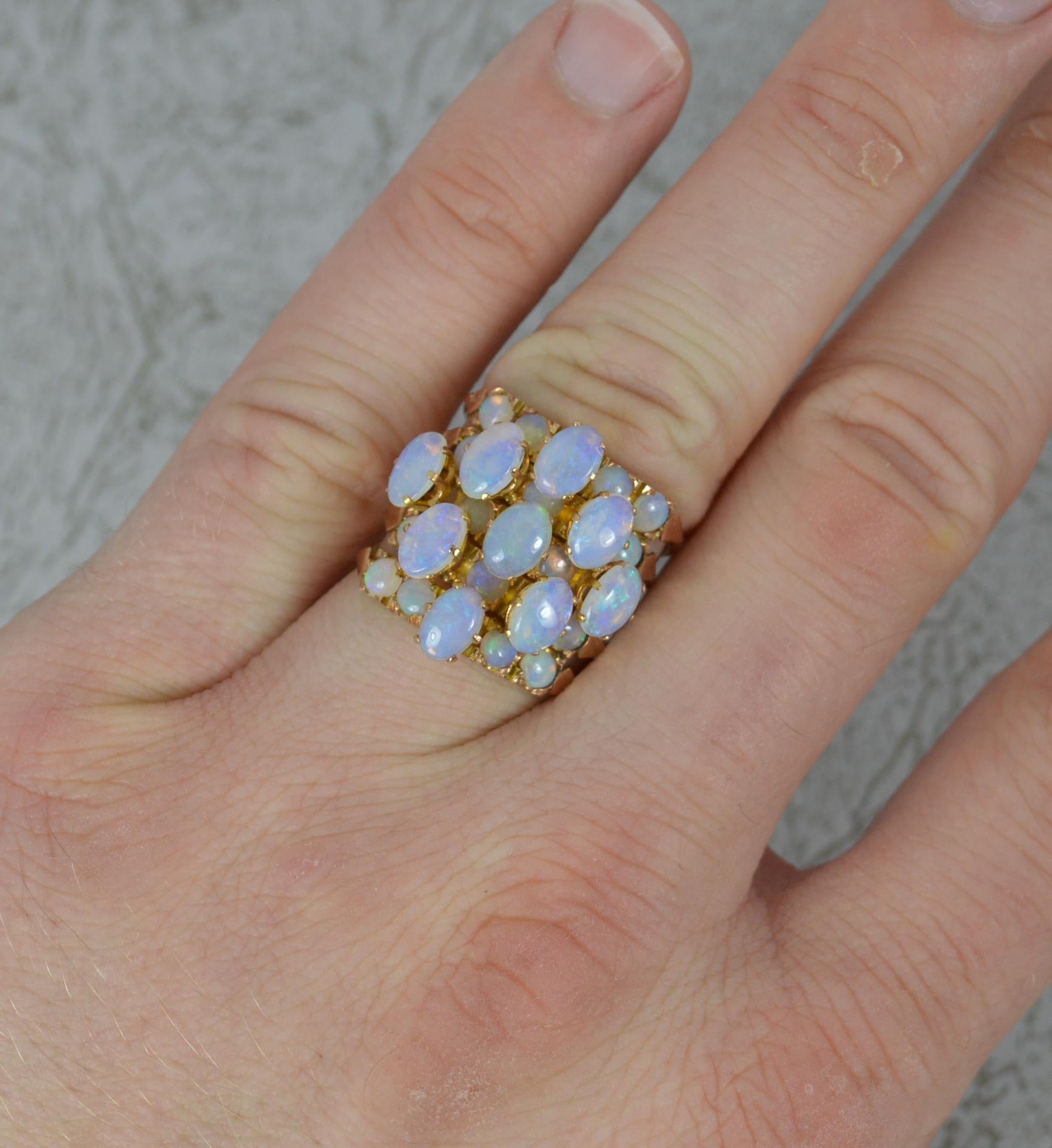 A late Victorian opal ring.
Solid 14 carat rose gold example.
Designed as five rows of half hoop stack rings all connected together.
Set with both round and oval shaped natural opals. 
20mm spread of stones. 18mm wide band to front.

CONDITION ;