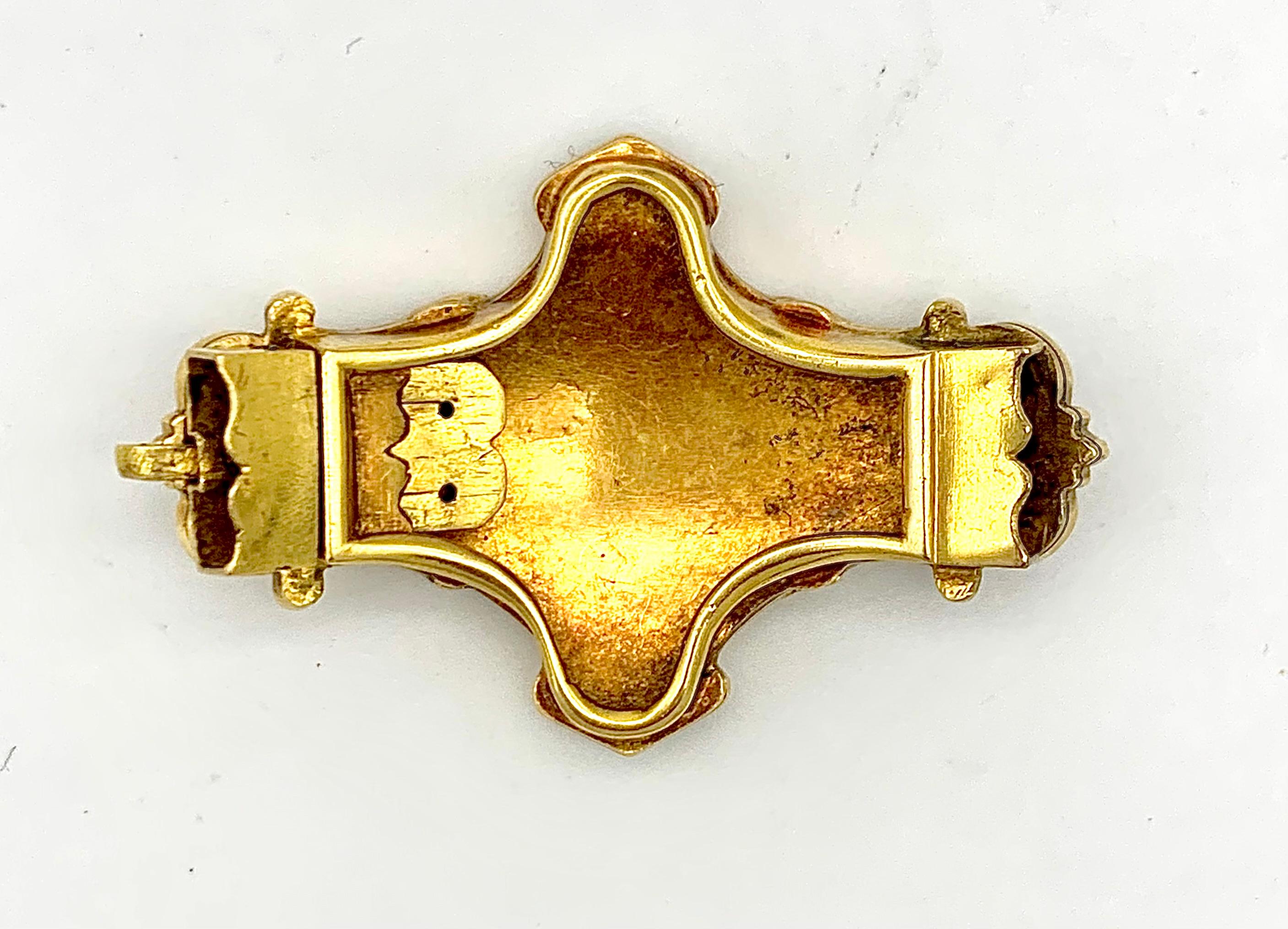 This solid gold clasp is decorated with fine bright royal blue guilloché enamel within a gold mount of rocaille and accanthus foliage.