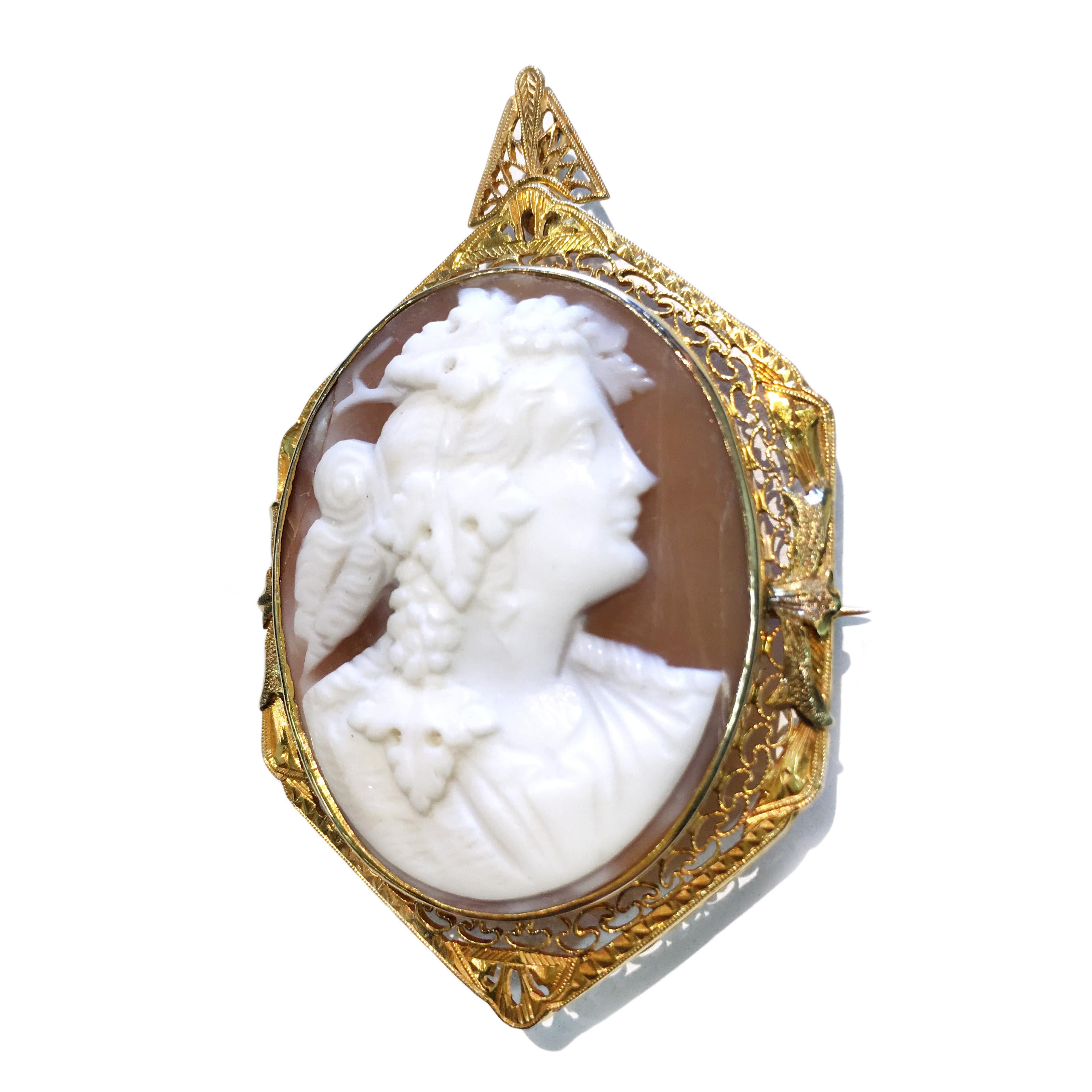 Antique 14 Karat Carved Shell Cameo Brooch Pendant with engraved filigree around octagon bezel. Portrait of an Apache with grapes and leaves on and around his head. The size of the brooch pendant with bail is approximate 56.27mm x 35.33mm. It could