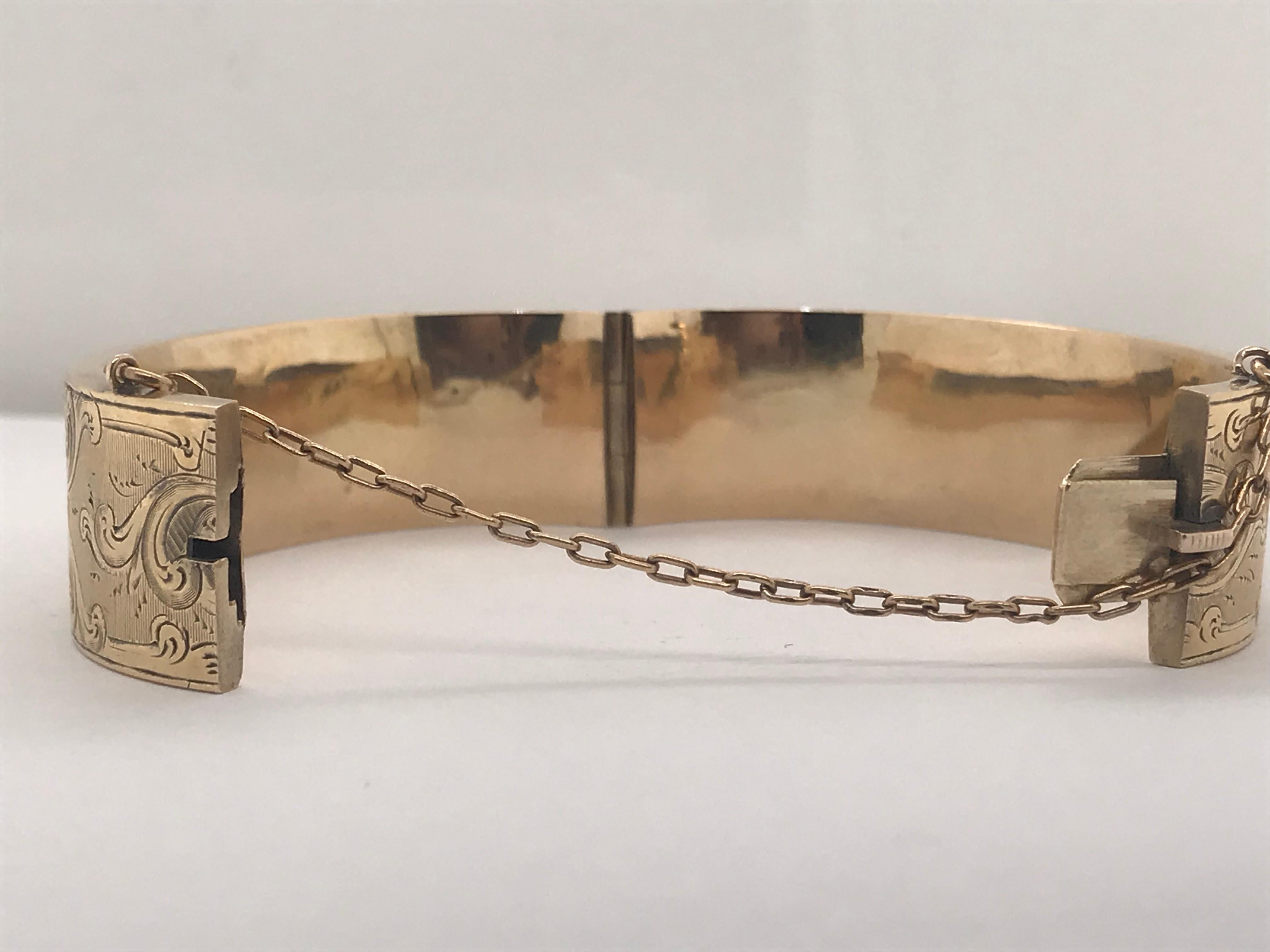 Antique 14 Karat Gold, Child-Sized, Bangle Bracelet, circa 1880. Fully detailed with beautiful floral hand engraving completely encompassing the bangle bracelet. Will comfortably fit 5-inch wrist. The bangle has a secure closure and opening. It is