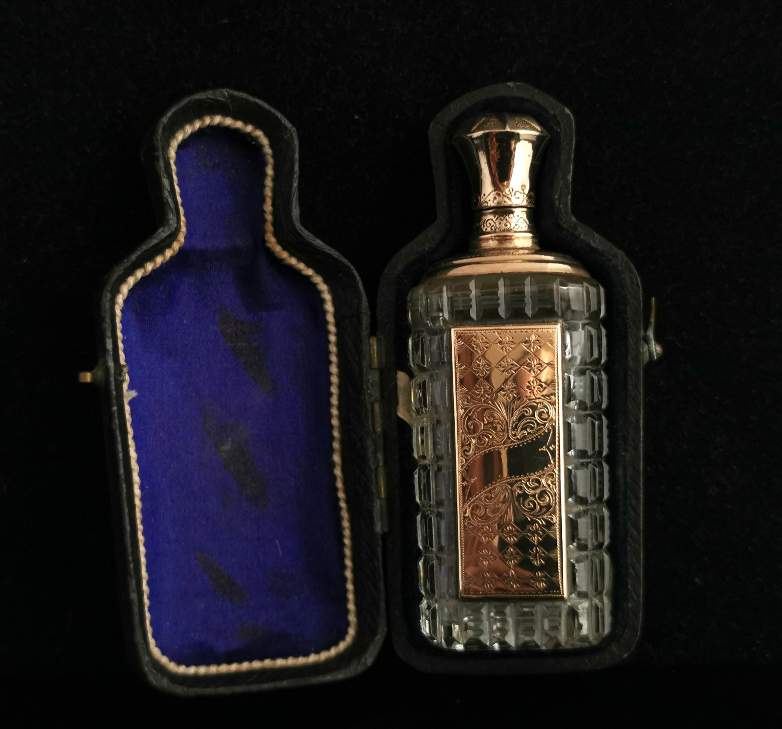 A stunning antique late 19th century 14 karat gold and cut glass scent bottle.

This is an absolute stunner with the chunky faceted cut reflecting the light beautifully from the facets, the front has an applied Rose gold panel with an engraved