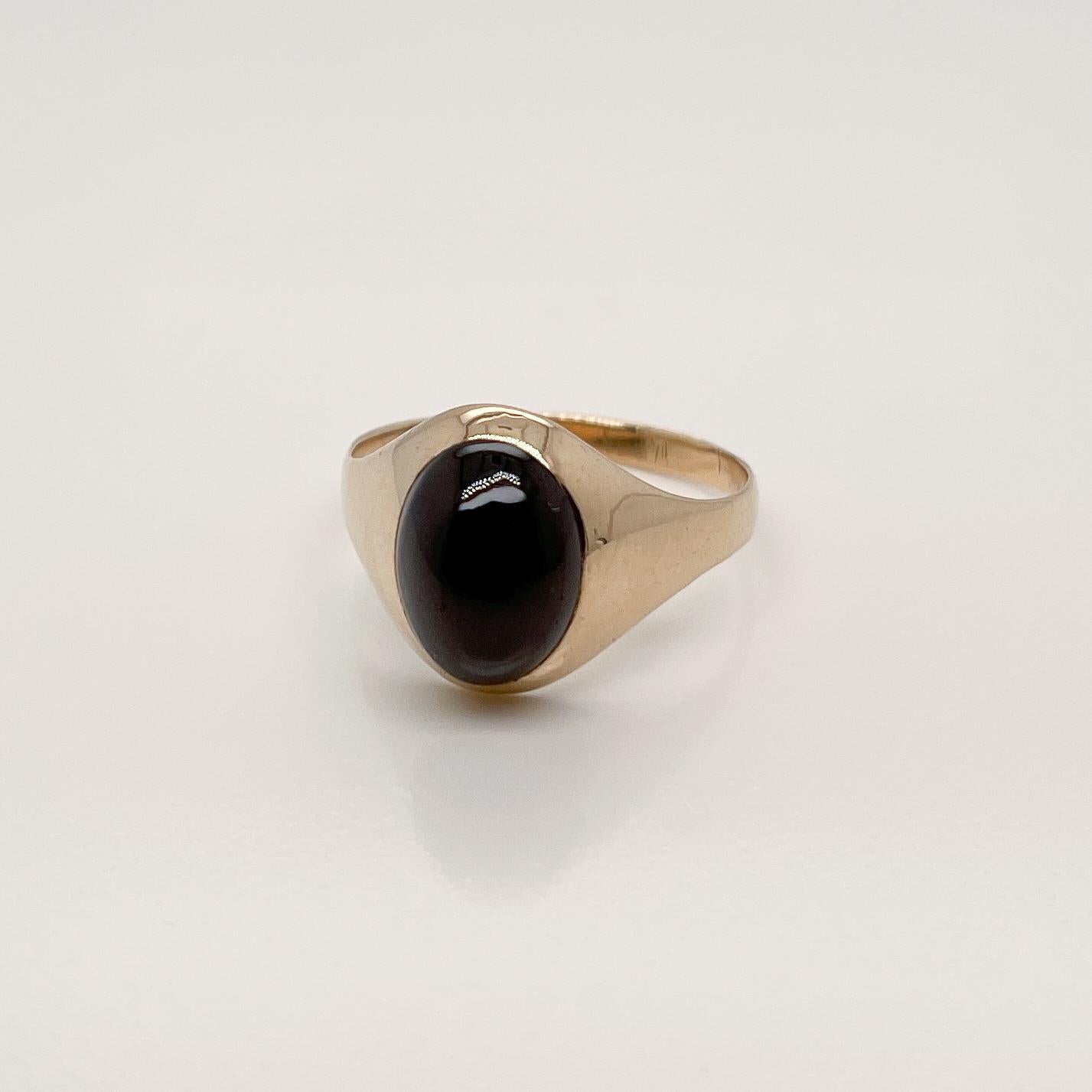 A very fine antique gold and garnet signet style ring.

Set with a large, dark oval garnet cabochon in 14k gold.

Simply a terrific ring!

Date:
20th Century

Overall Condition:
It is in overall good, as-pictured, used estate condition with some
